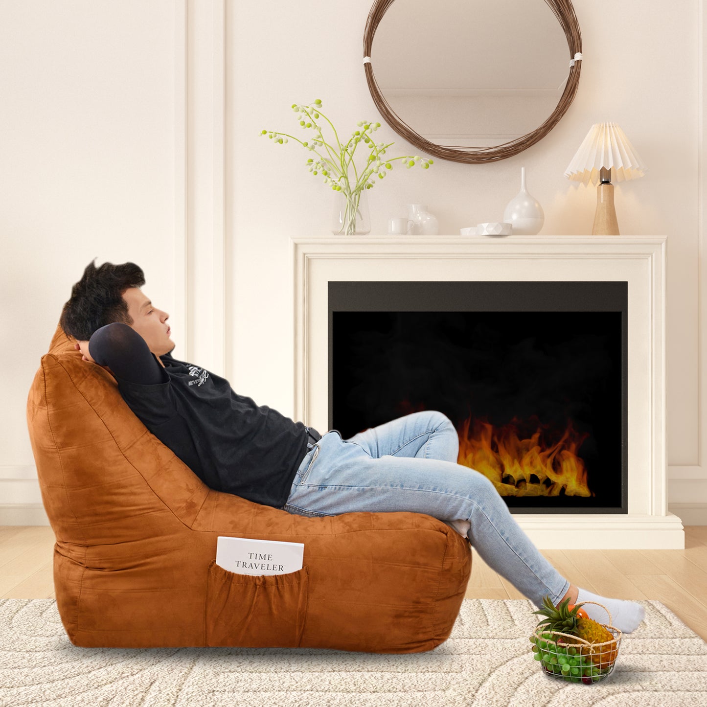 Brown suede bean bag chair with side pocket holding a book placed on a textured rug