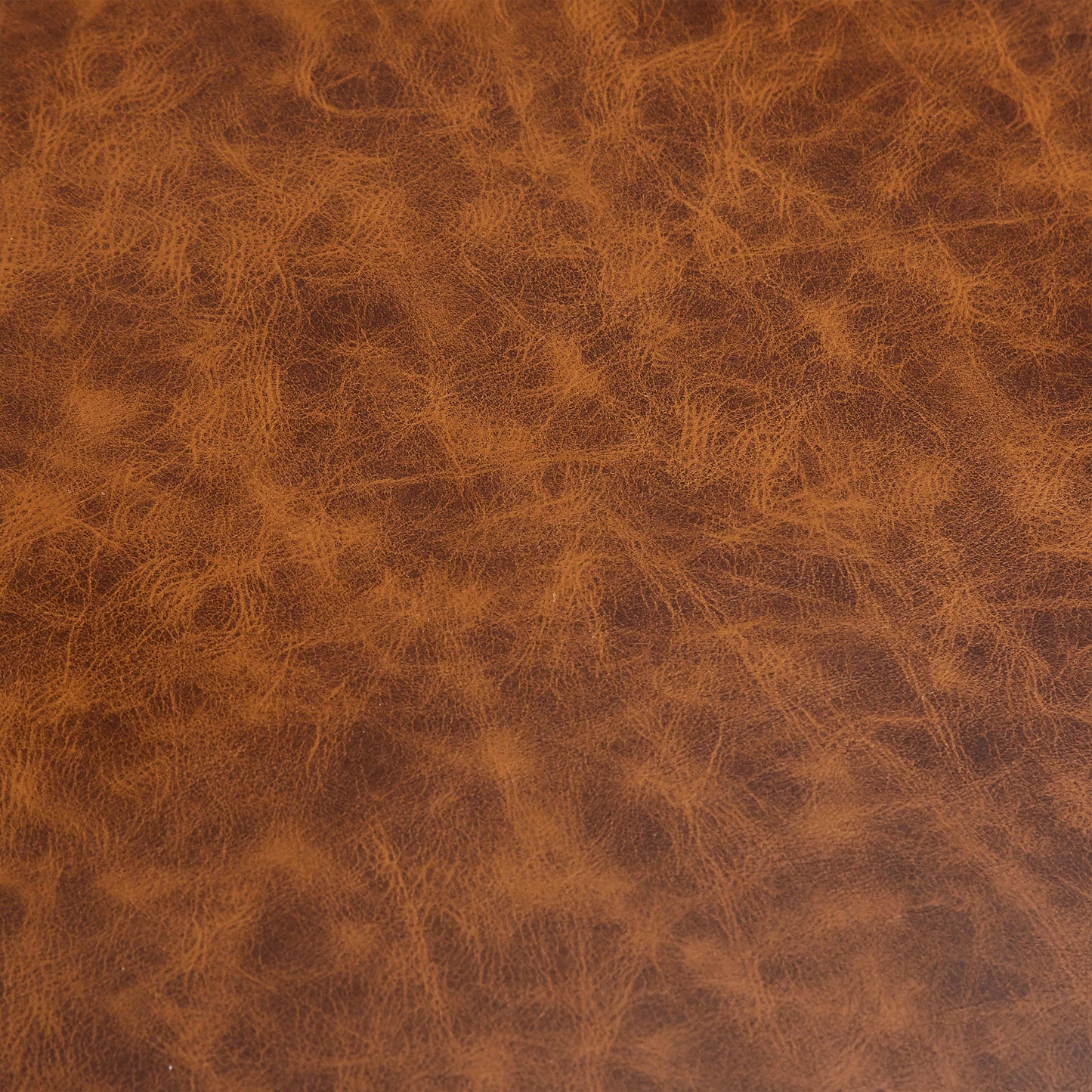 Rich cognac brown distressed genuine leather texture ideal for upholstery and accessories