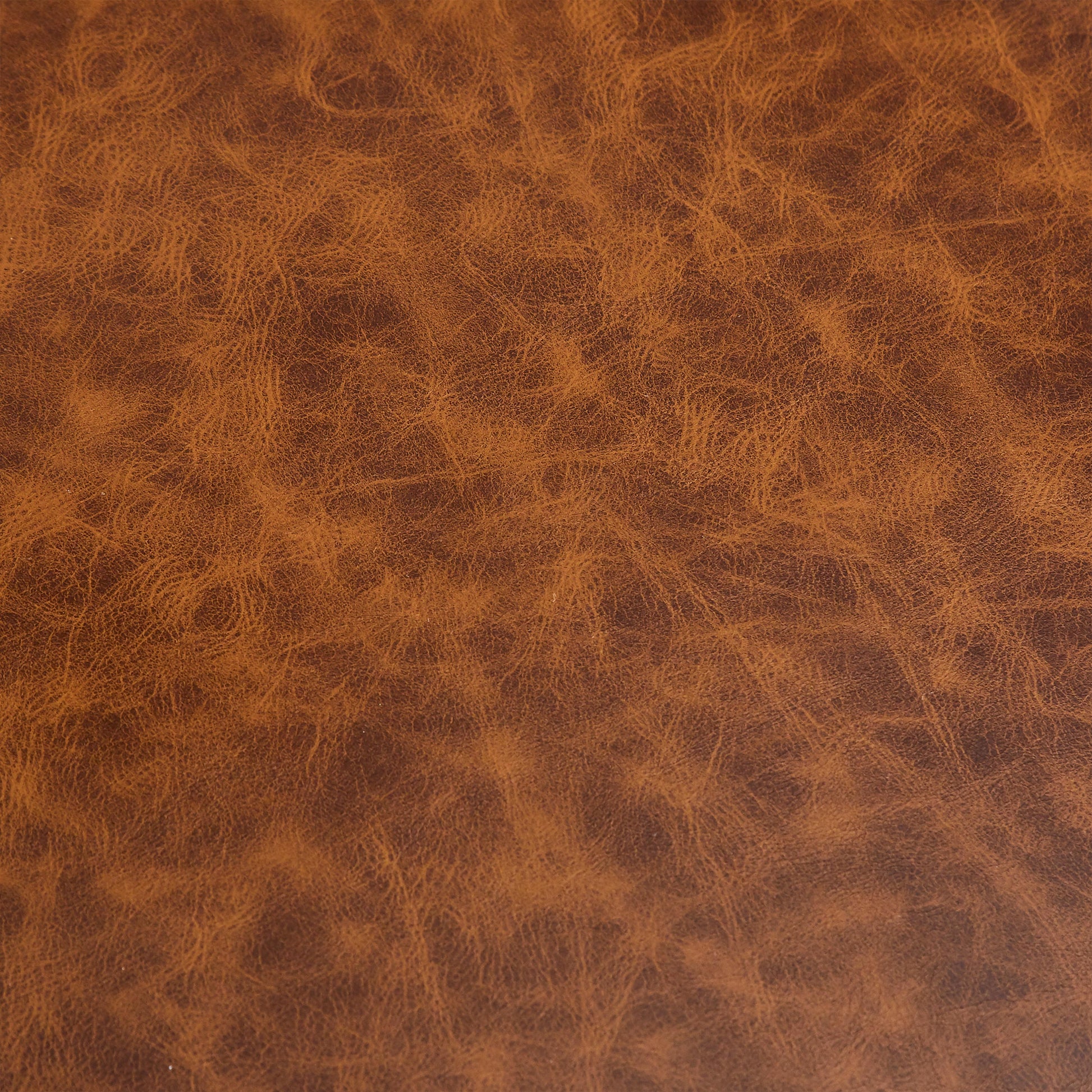 Rich cognac brown distressed genuine leather texture ideal for upholstery and accessories