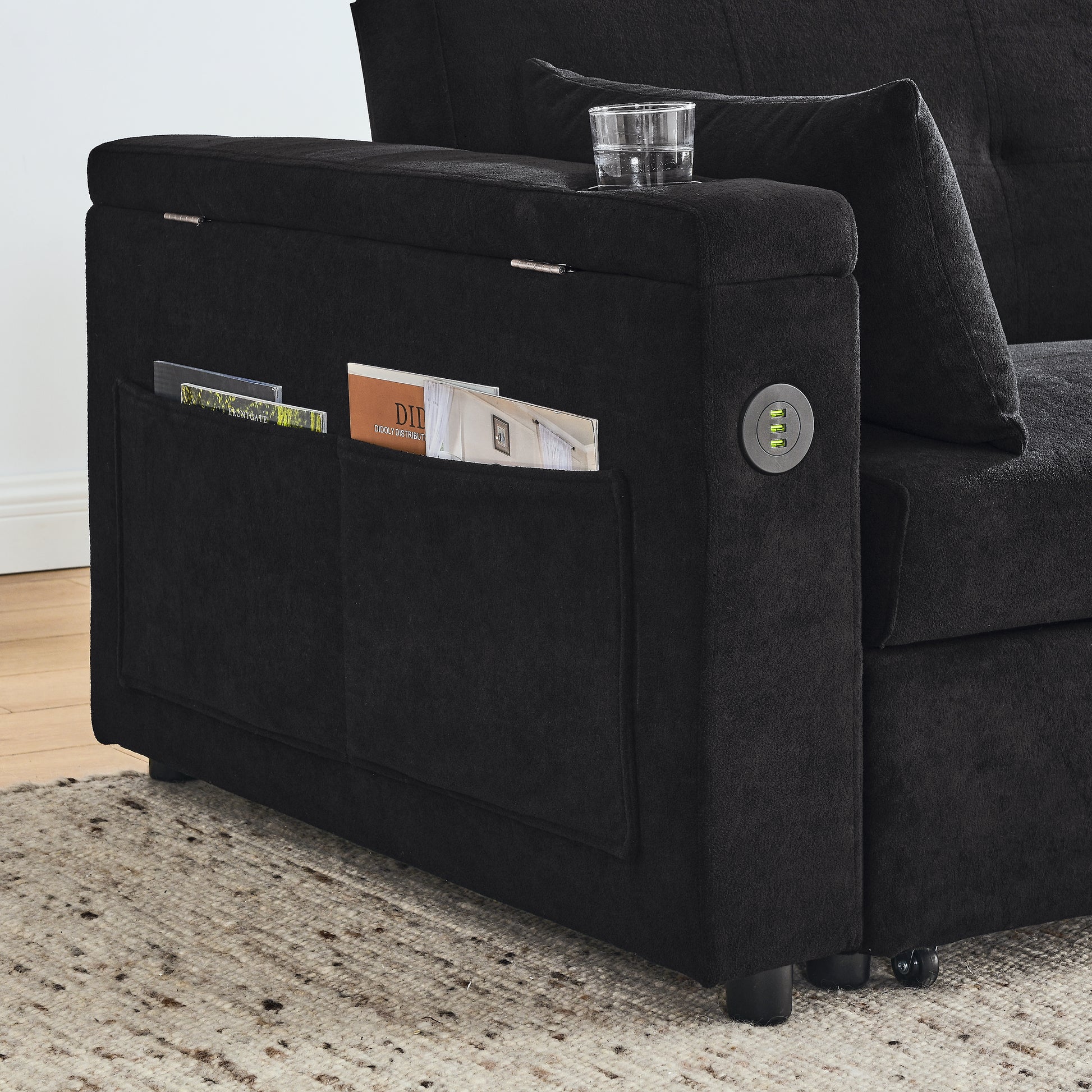Black fabric sofa armrest with integrated USB charging ports and storage pockets