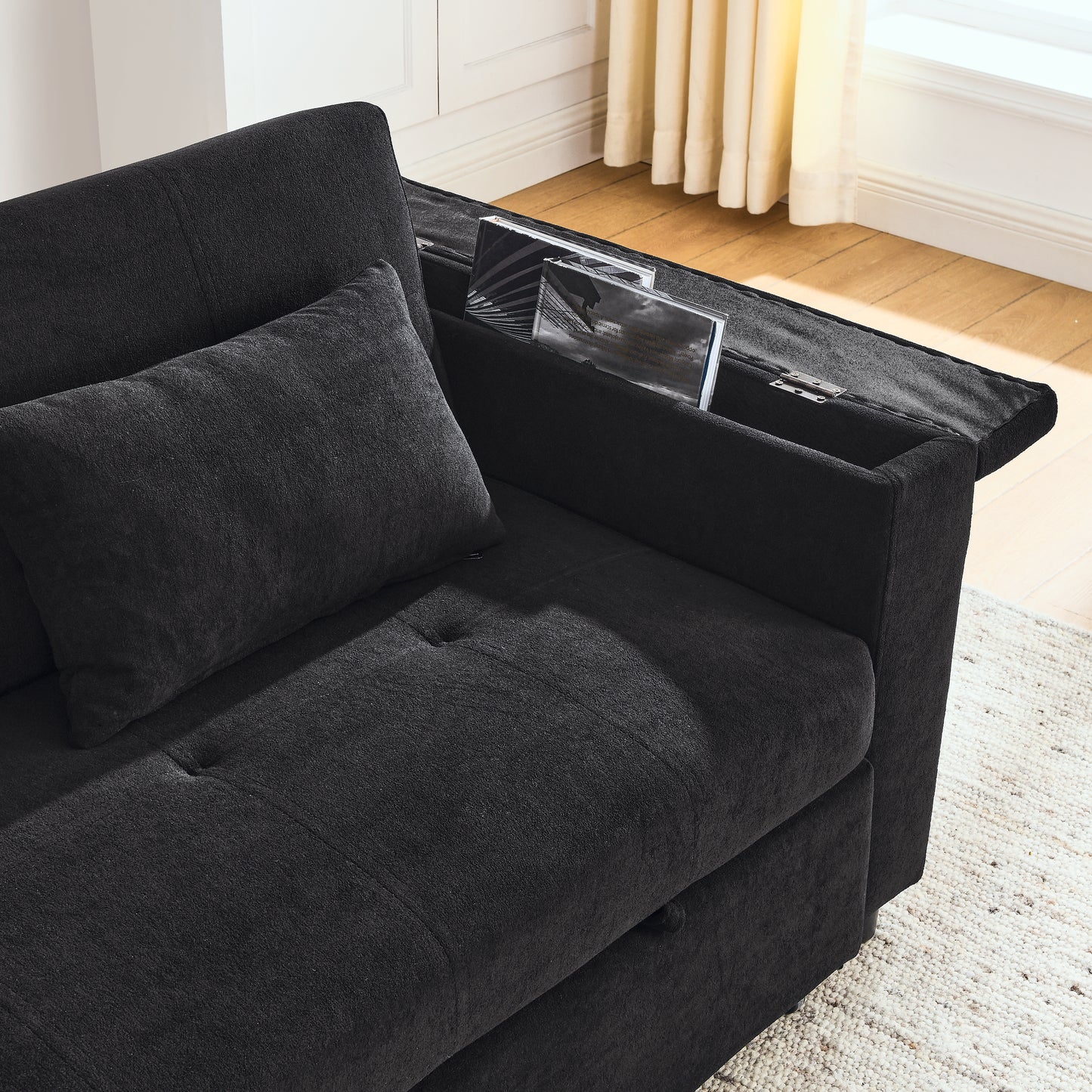Dark charcoal gray fabric sectional sofa with builtin armrest storage for books