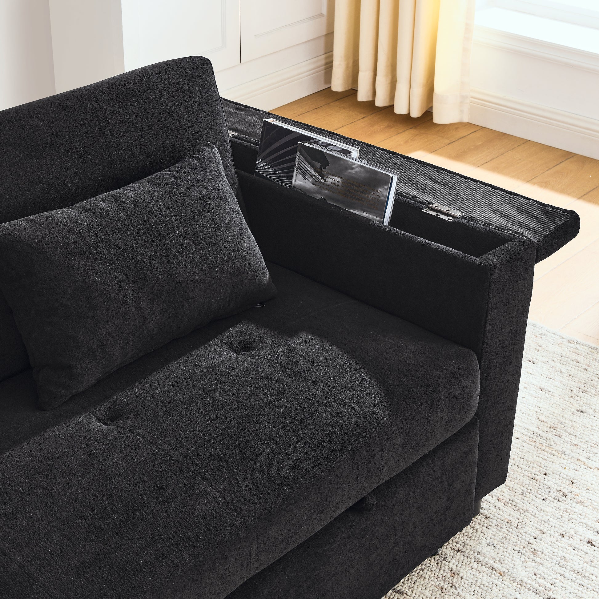 Dark charcoal gray fabric sectional sofa with builtin armrest storage for books