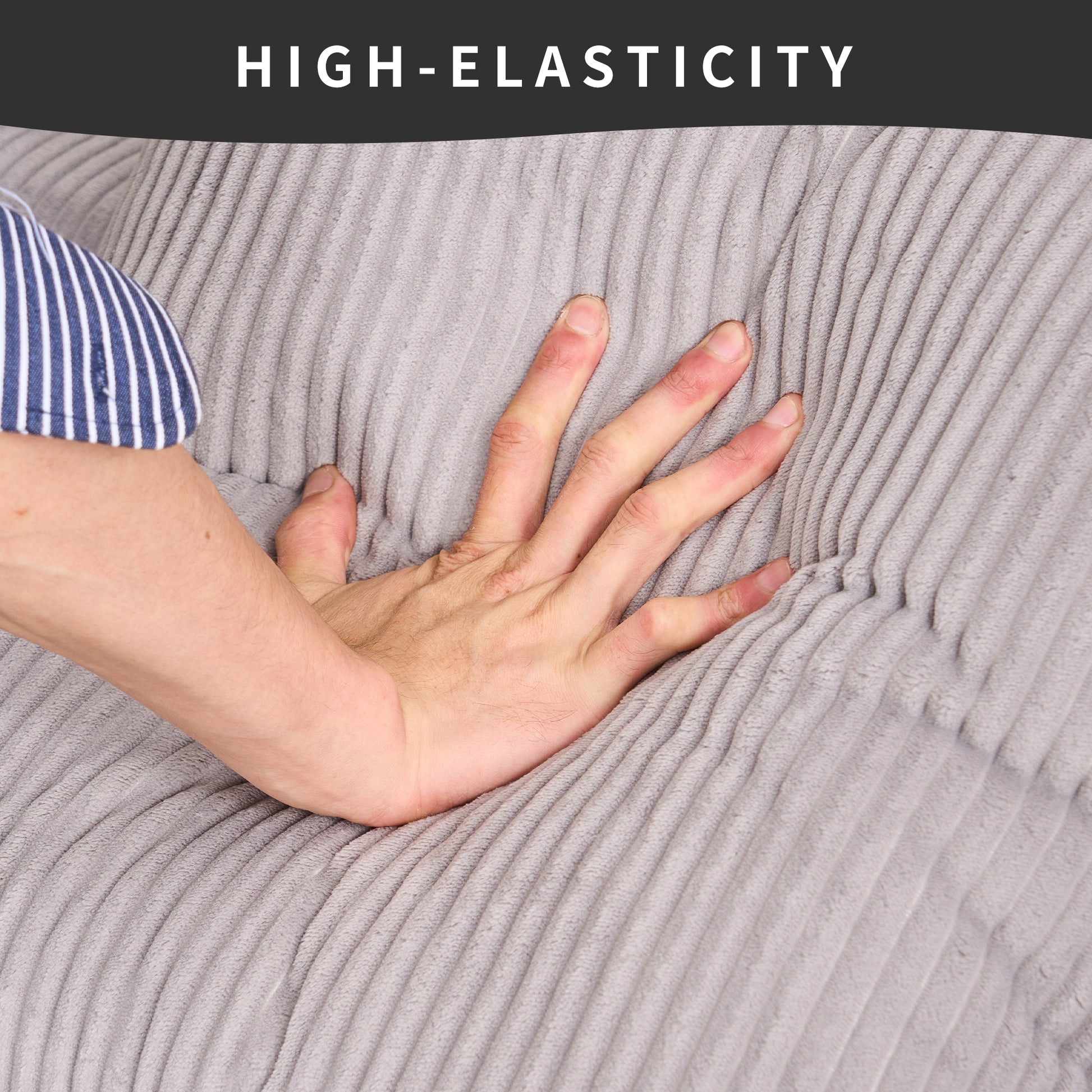 Closeup of a hand pressing into plush grey corduroy fabric showcasing highelasticity material