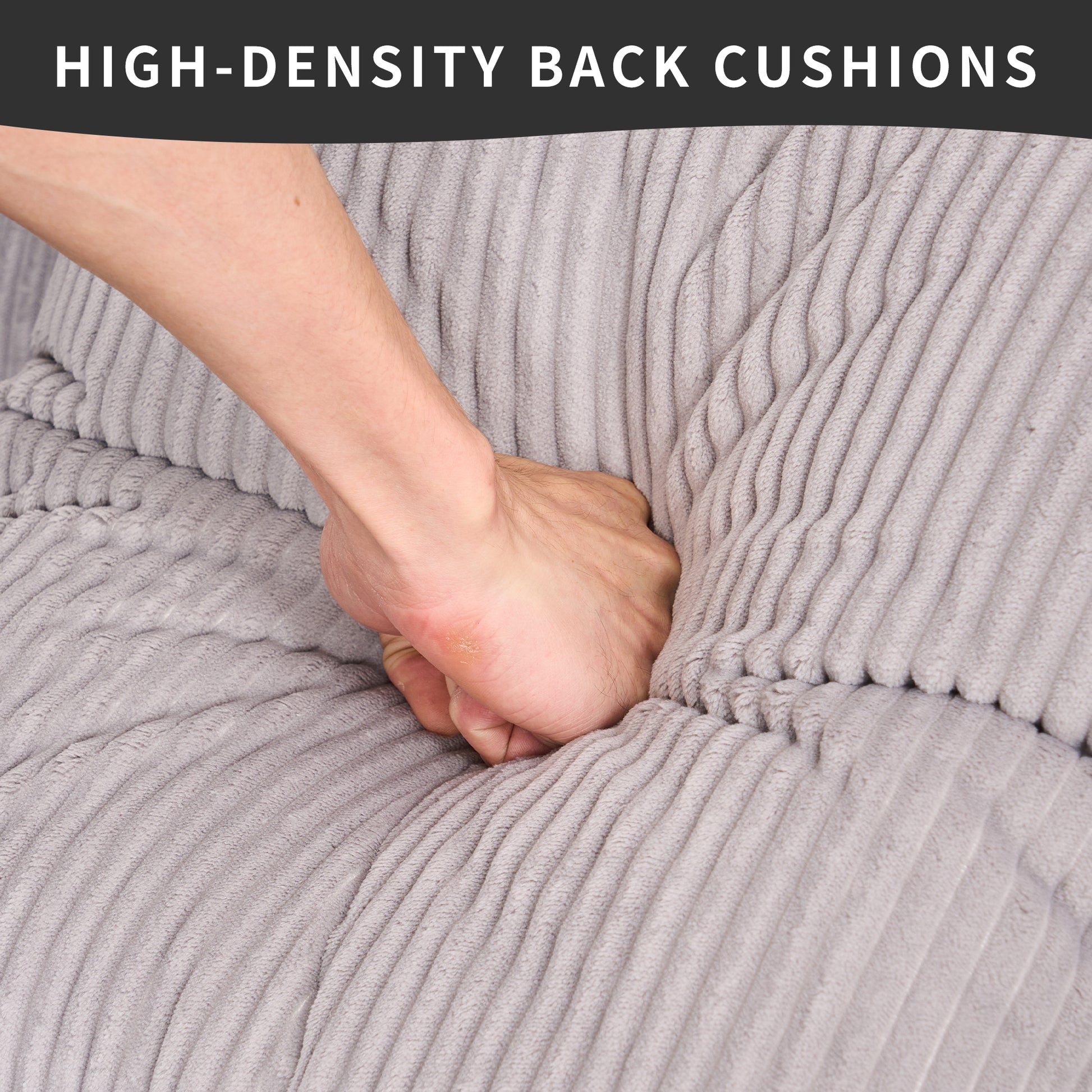 Hand pressing into soft grey corduroy sofa cushions demonstrating highdensity comfort