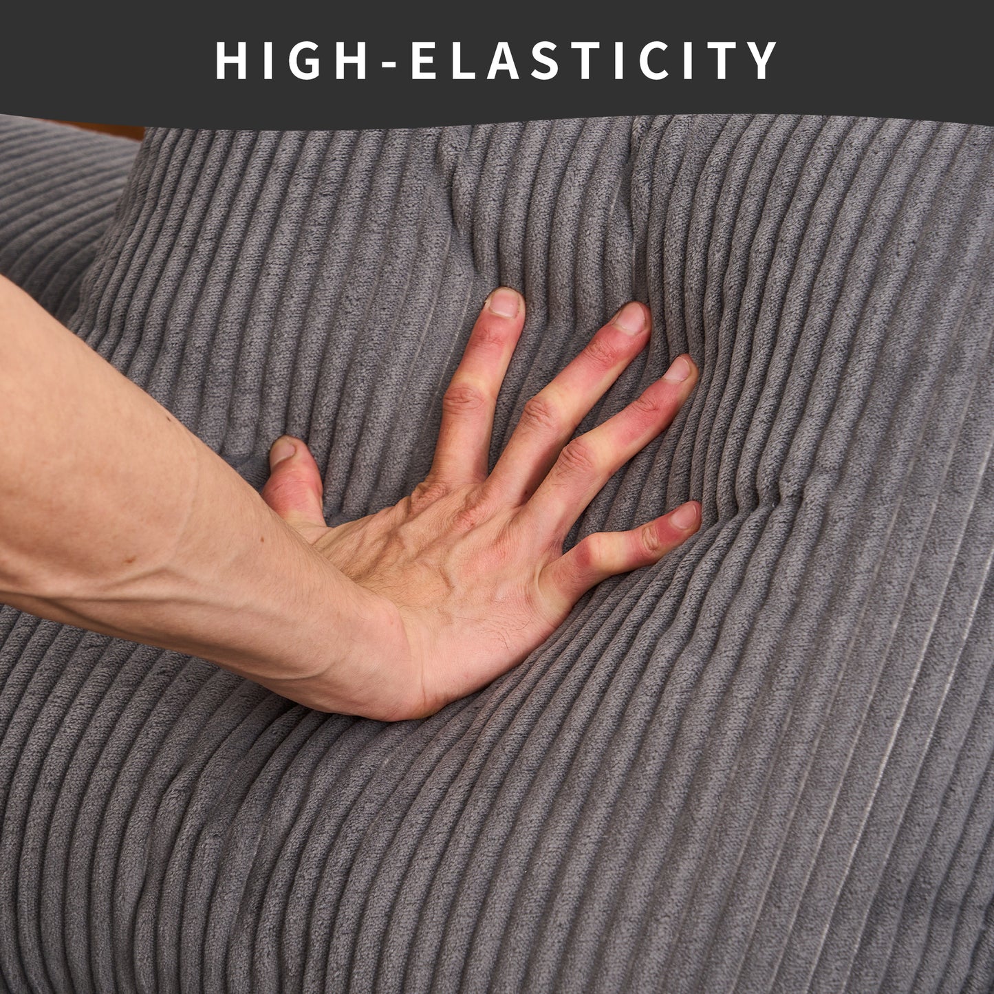 Closeup of a hand pressing into soft grey corduroy fabric showcasing its high elasticity