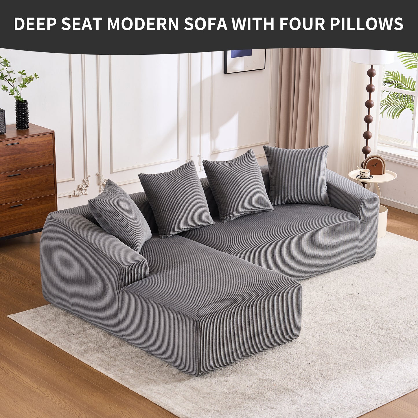 Deep grey corduroy sectional sofa with four matching throw pillows and a chaise