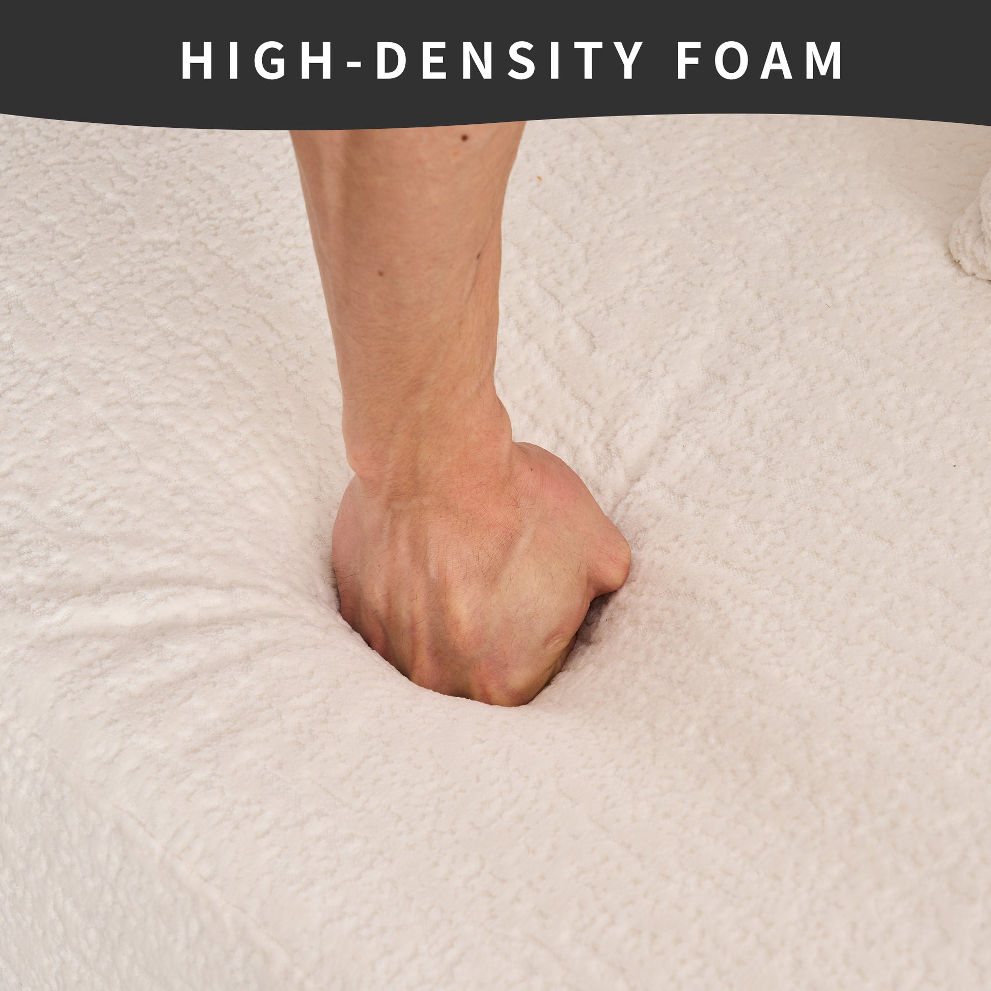 Hand pressing into plush creamcolored highdensity foam mattress topper