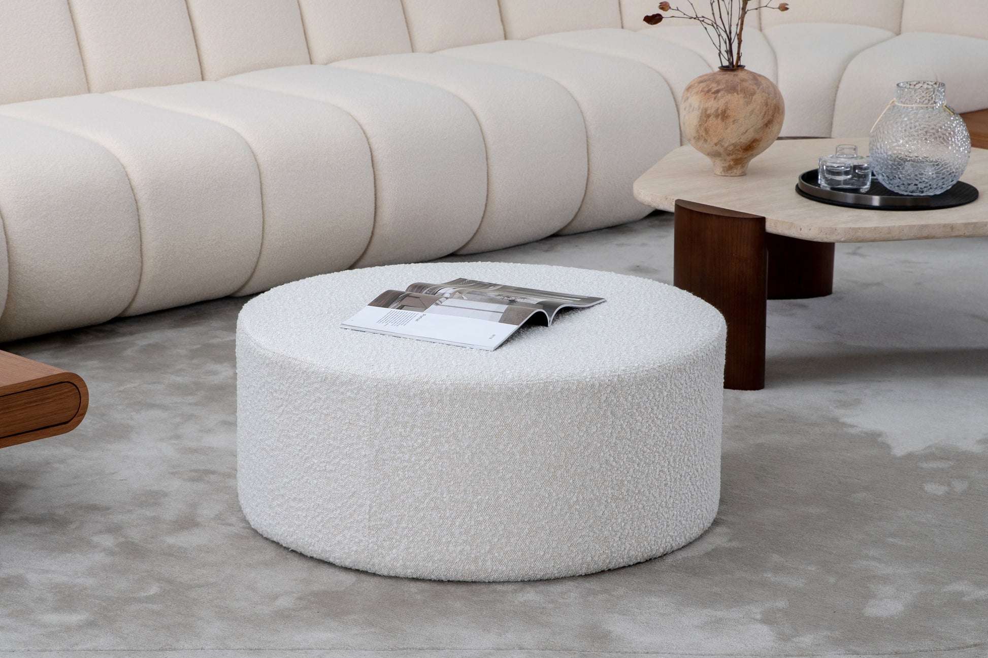 Textured boucle ottoman in cream perfect as a footrest or extra seating in a modern living room