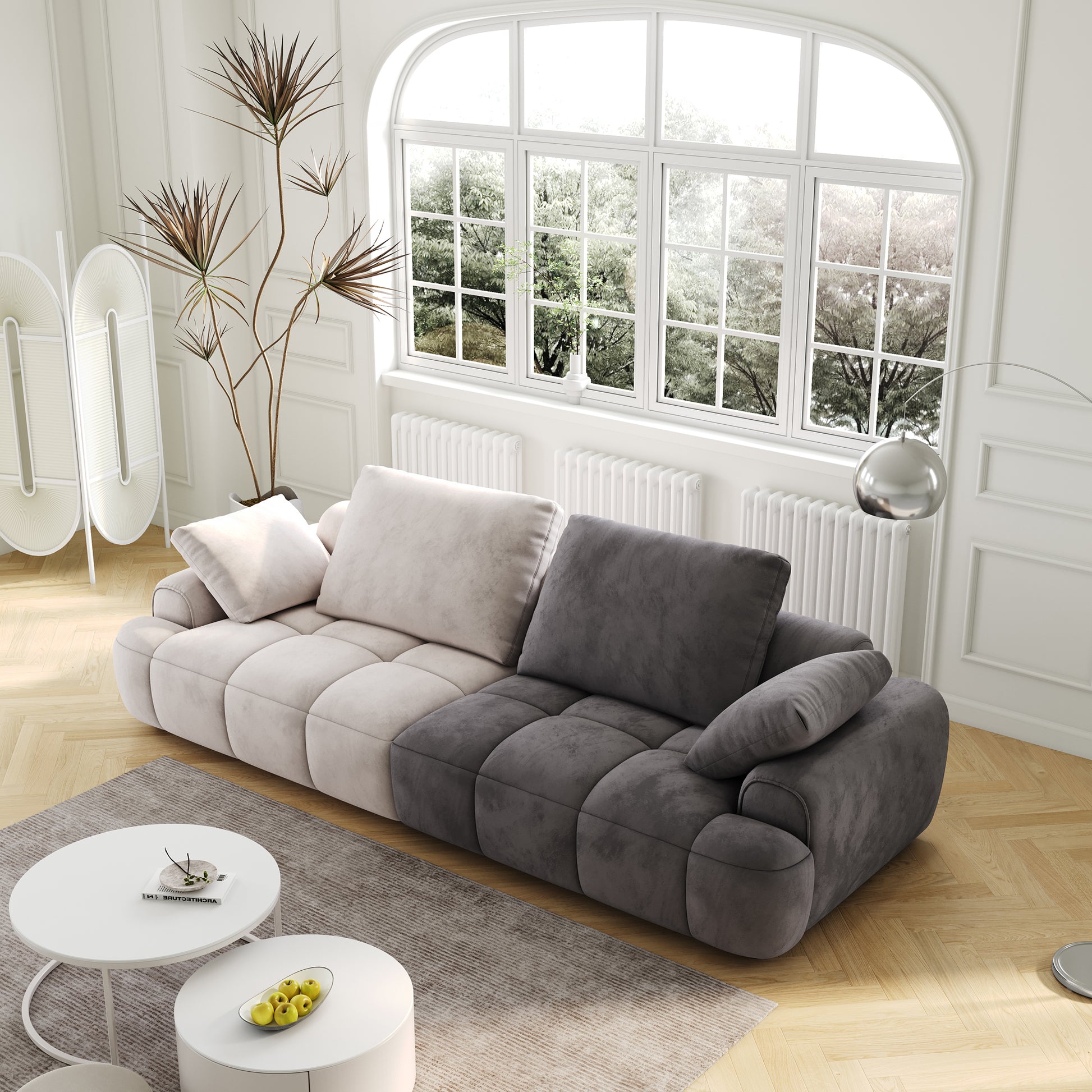 Modular velvet sofa in cream and charcoal featuring deep tufting and plush cushions for ultimate comfort