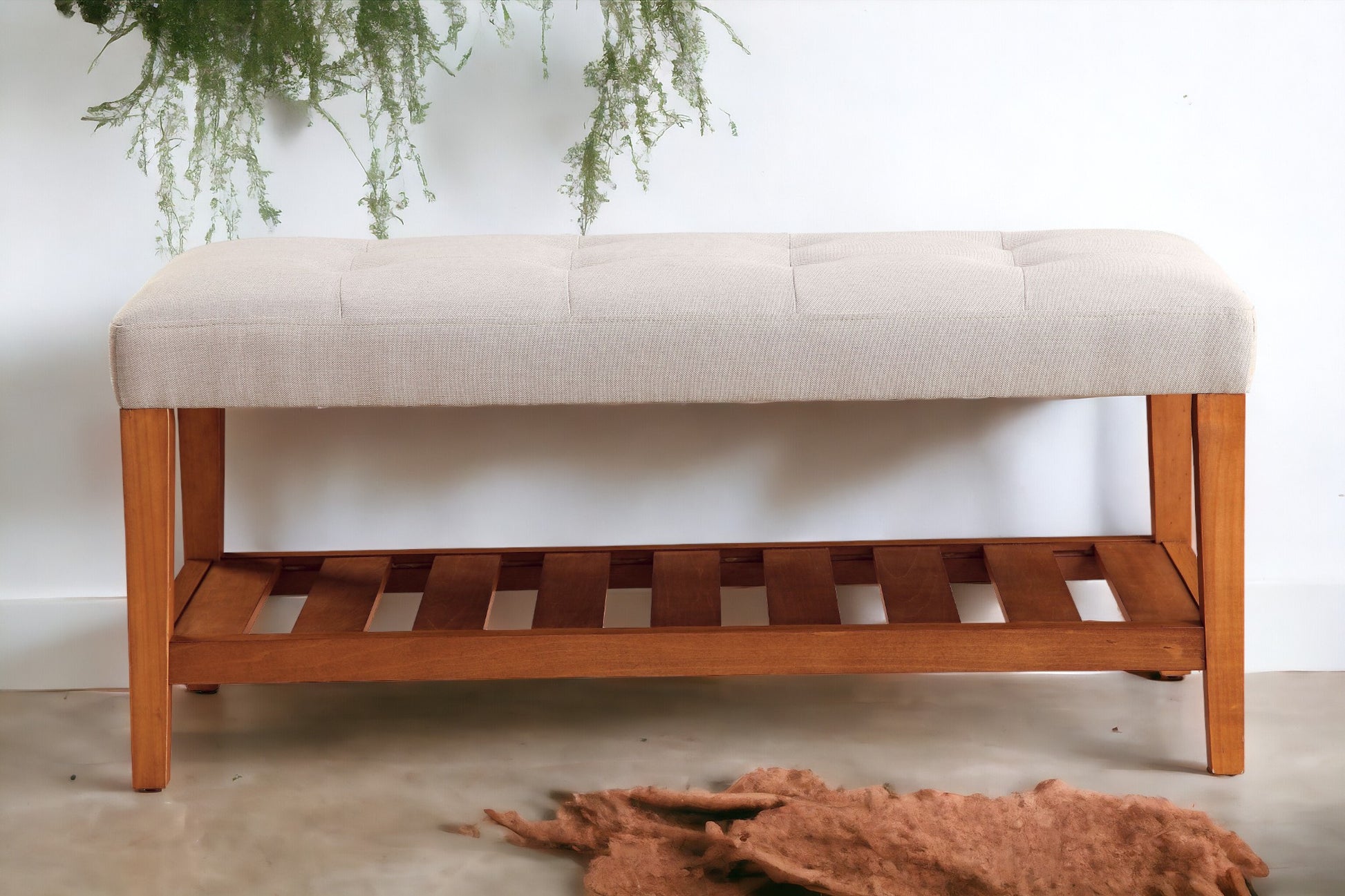Tufted beige fabric bench with wooden slatted shelf