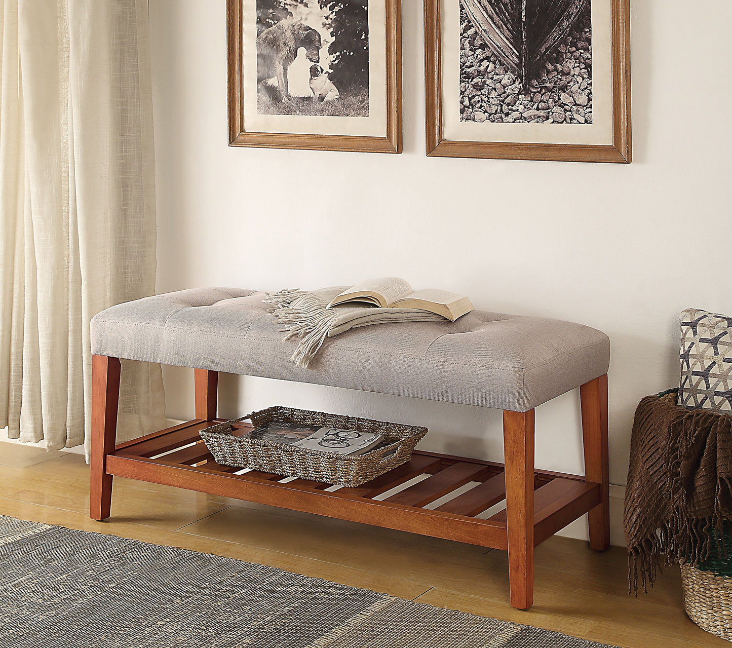 Tufted grey upholstered bench with wooden legs and slatted shelf
