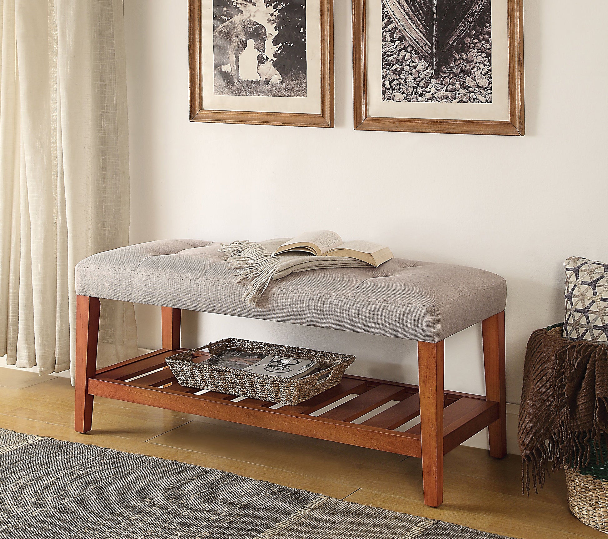 Tufted grey upholstered bench with wooden legs and slatted shelf