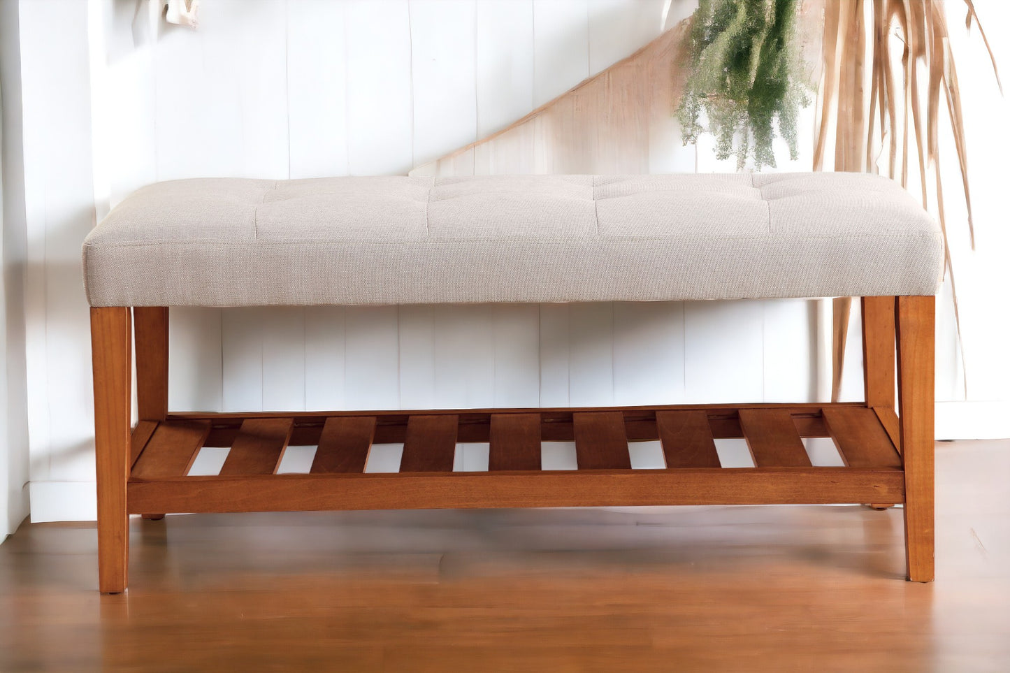 Tufted beige fabric bench with a slatted wooden base