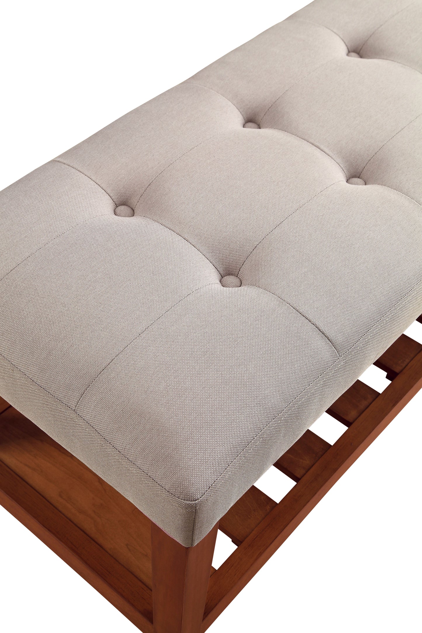Tufted cream upholstered bench with a dark wood frame