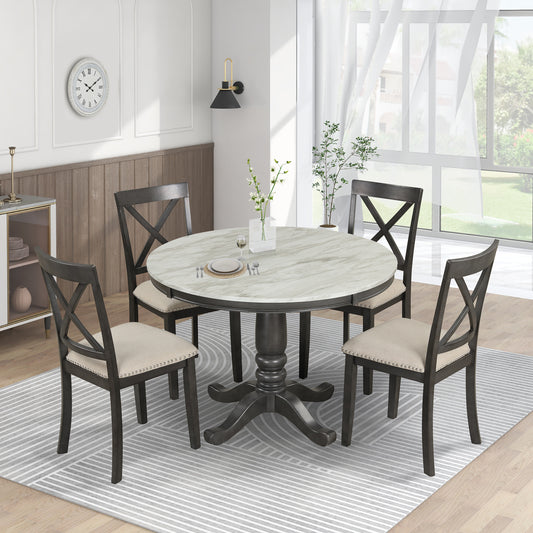 Dark gray pedestal dining table with marble top and upholstered chairs