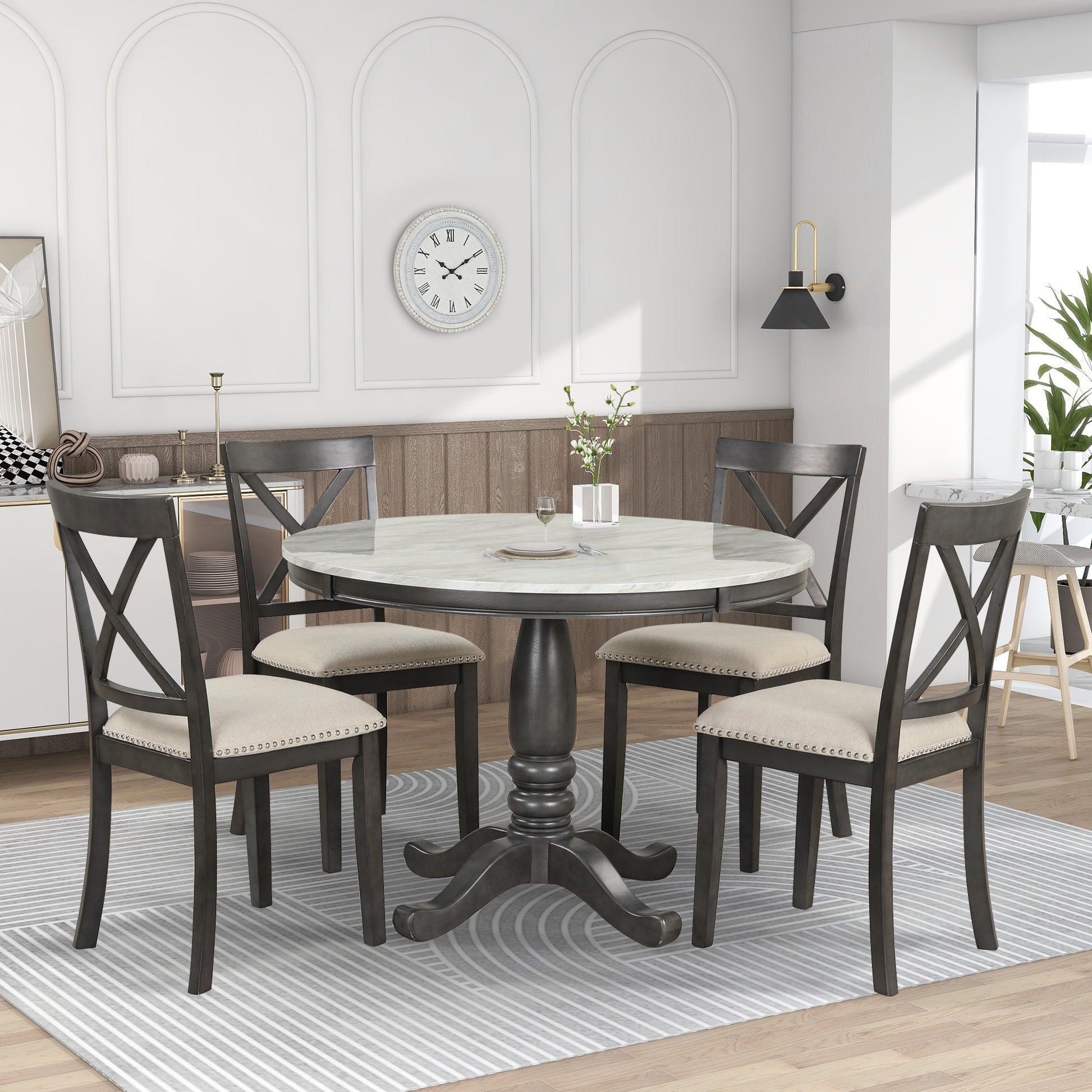 Dark gray round dining table with marblelook top and four upholstered chairs