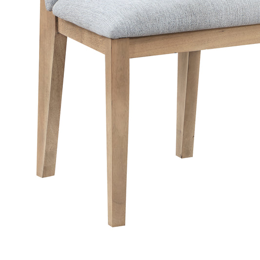 Closeup of light grey textured upholstered seat on a modern dining chair with natural wood legs