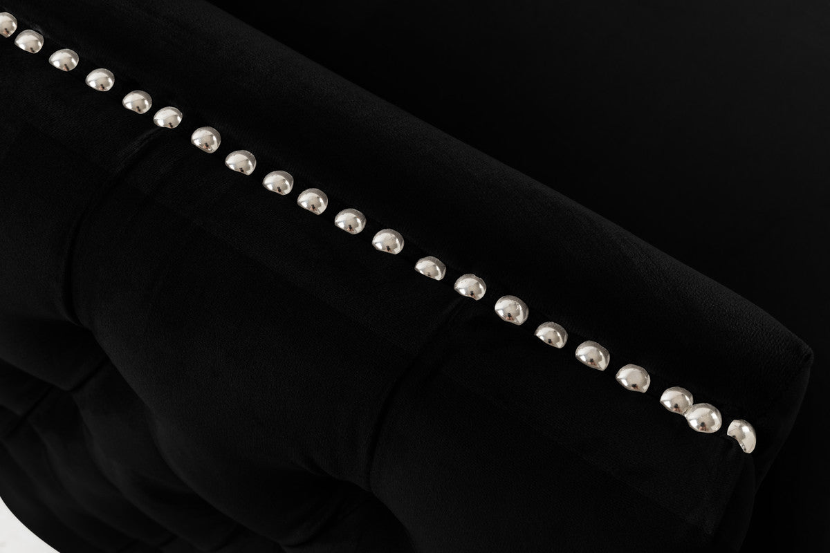 Black velvet armchair detail with silver stud trim