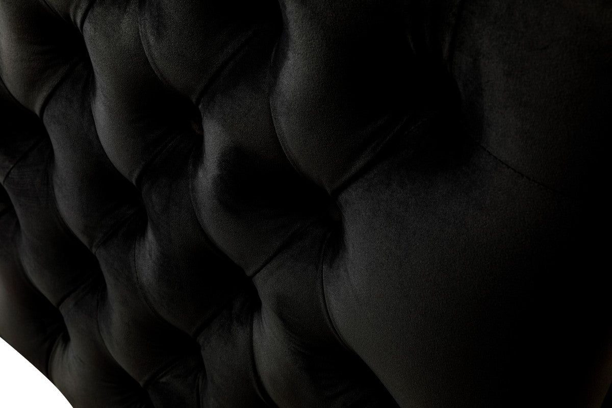 Closeup of black velvet upholstery with diamond tufting detail