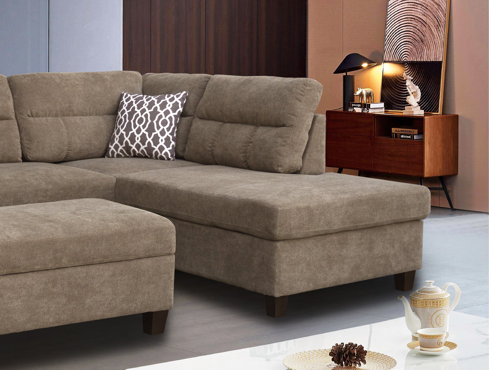 Taupe fabric sectional sofa with chaise lounge and patterned accent pillow for modern living rooms