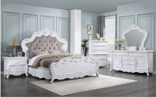 Ornate white upholstered bed frame with tufted headboard and matching nightstand