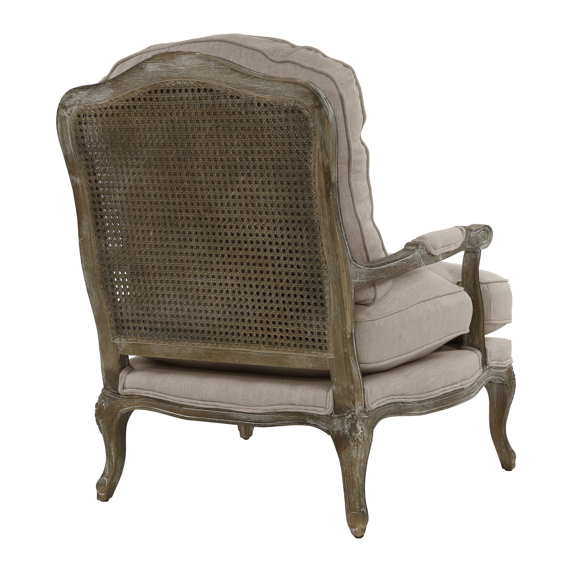 Antique cane back armchair with distressed wood frame and beige linen upholstery