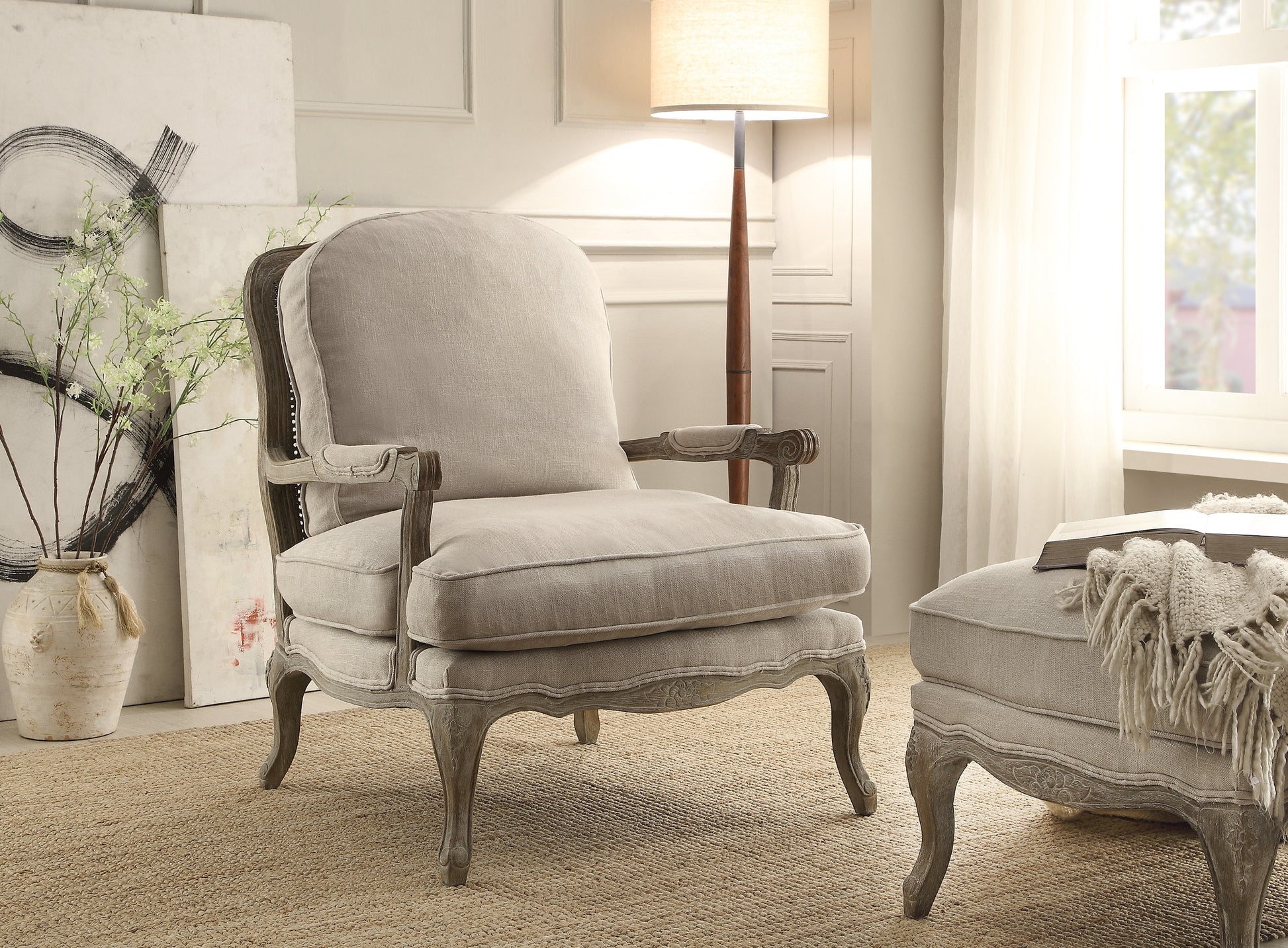 Elegant linen accent chair with carved wooden legs and decorative trim