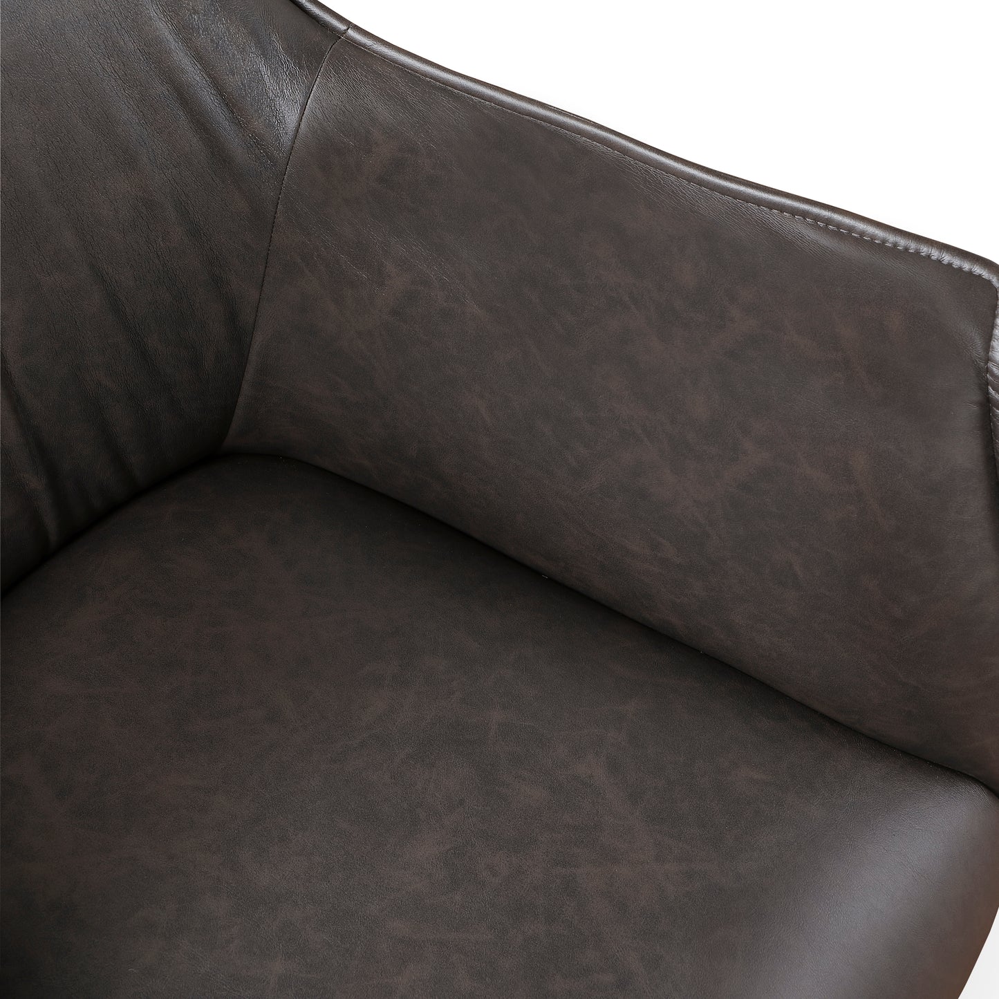 Closeup of a dark brown distressed leather armchair seat and armrest