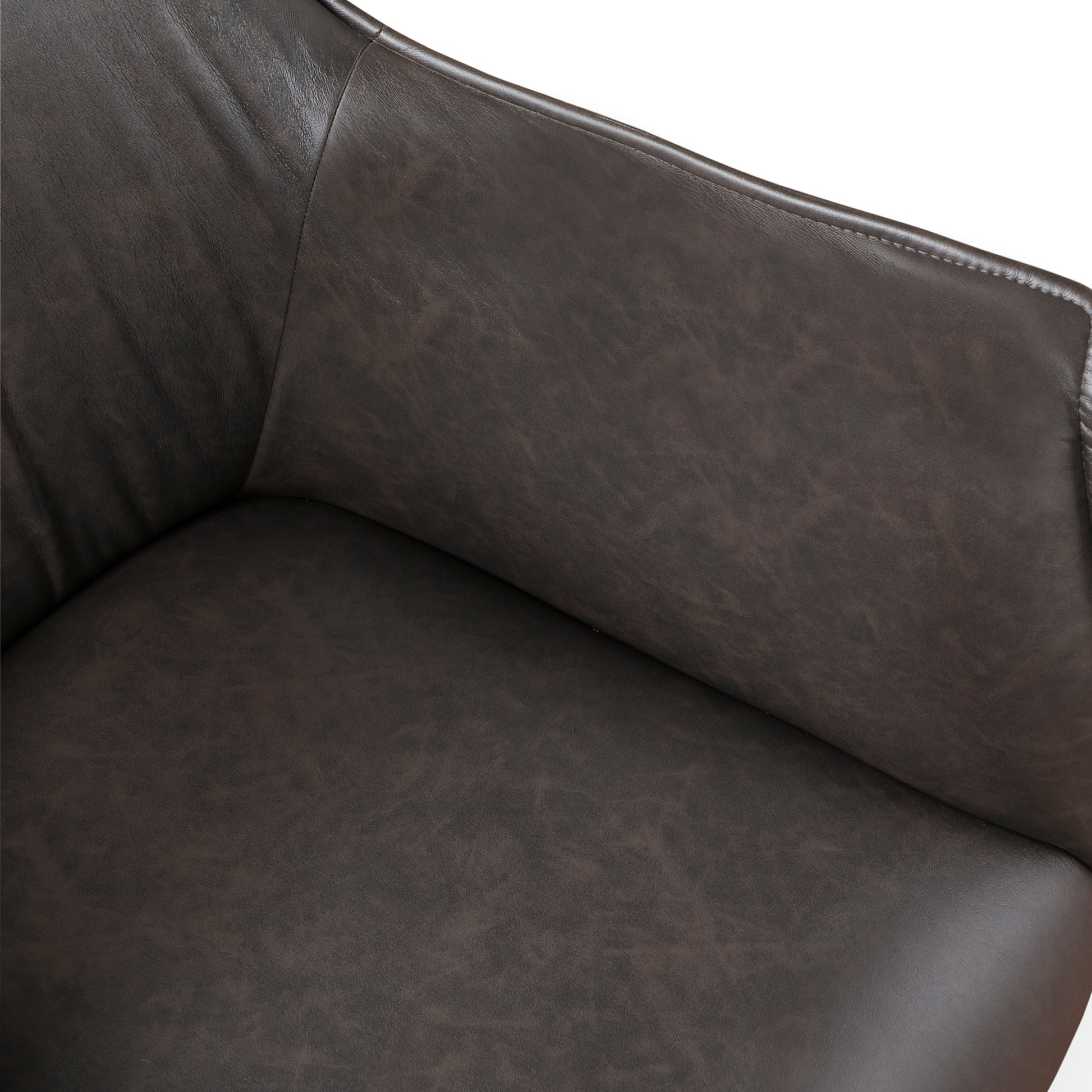 Closeup of a dark brown distressed leather armchair seat and armrest