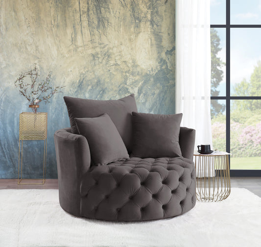 Plush grey velvet swivel accent chair with deep button tufting and comfortable throw pillows perfect for a cozy reading nook