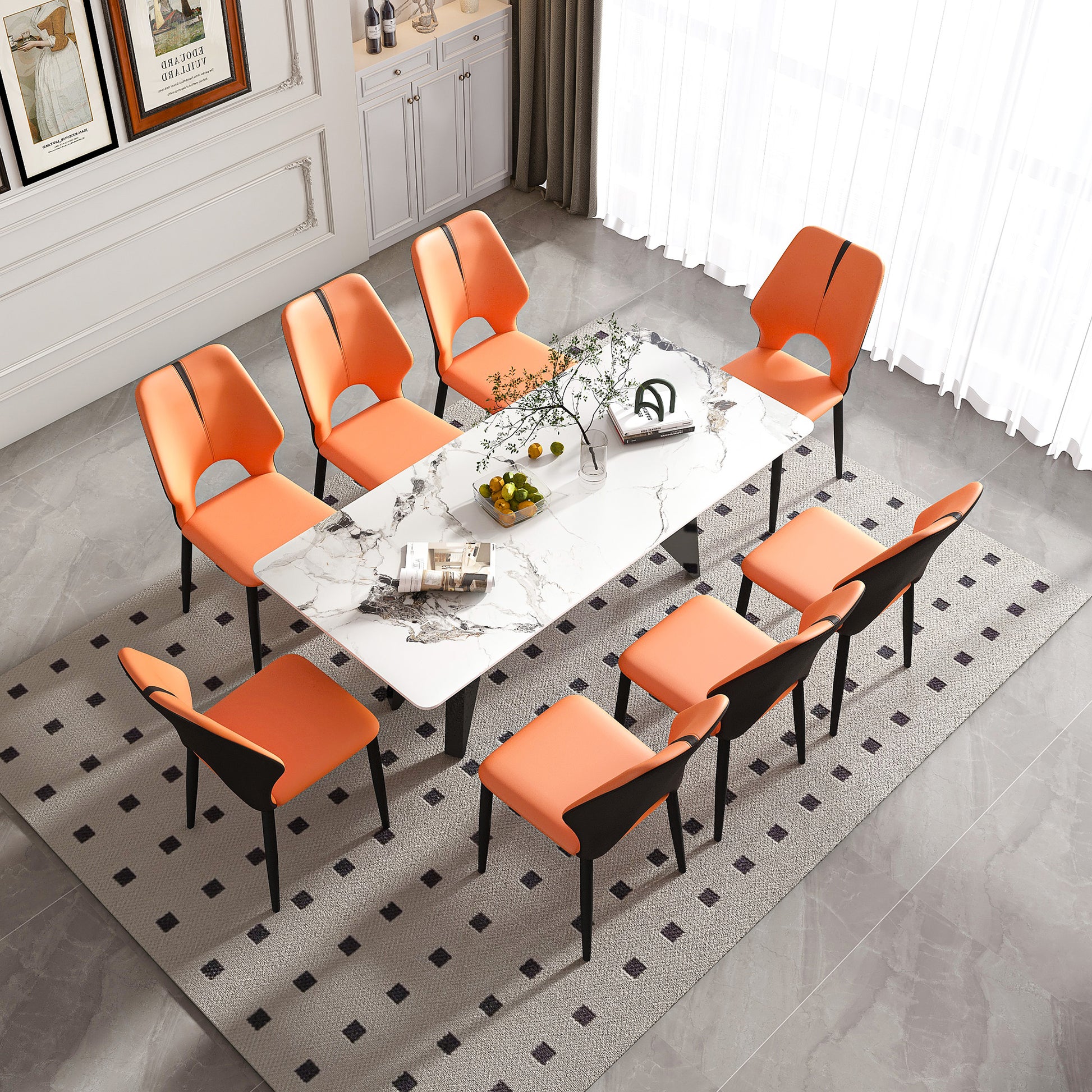 Orange upholstered dining chairs with black legs surrounding a marbletop table