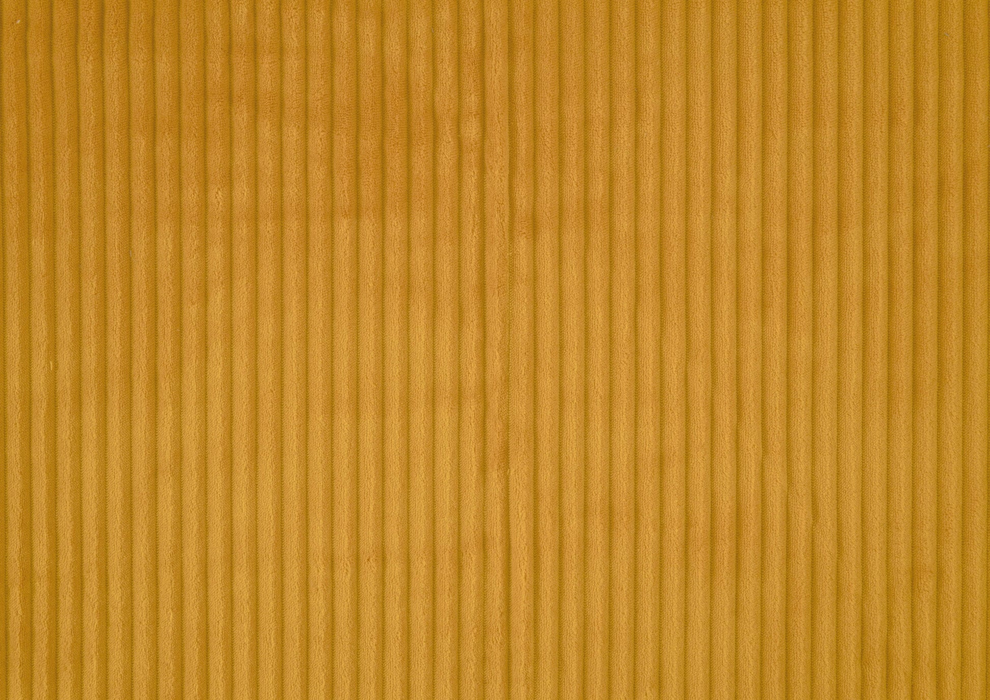 Golden brown corduroy fabric texture with vertical wales ideal for upholstery