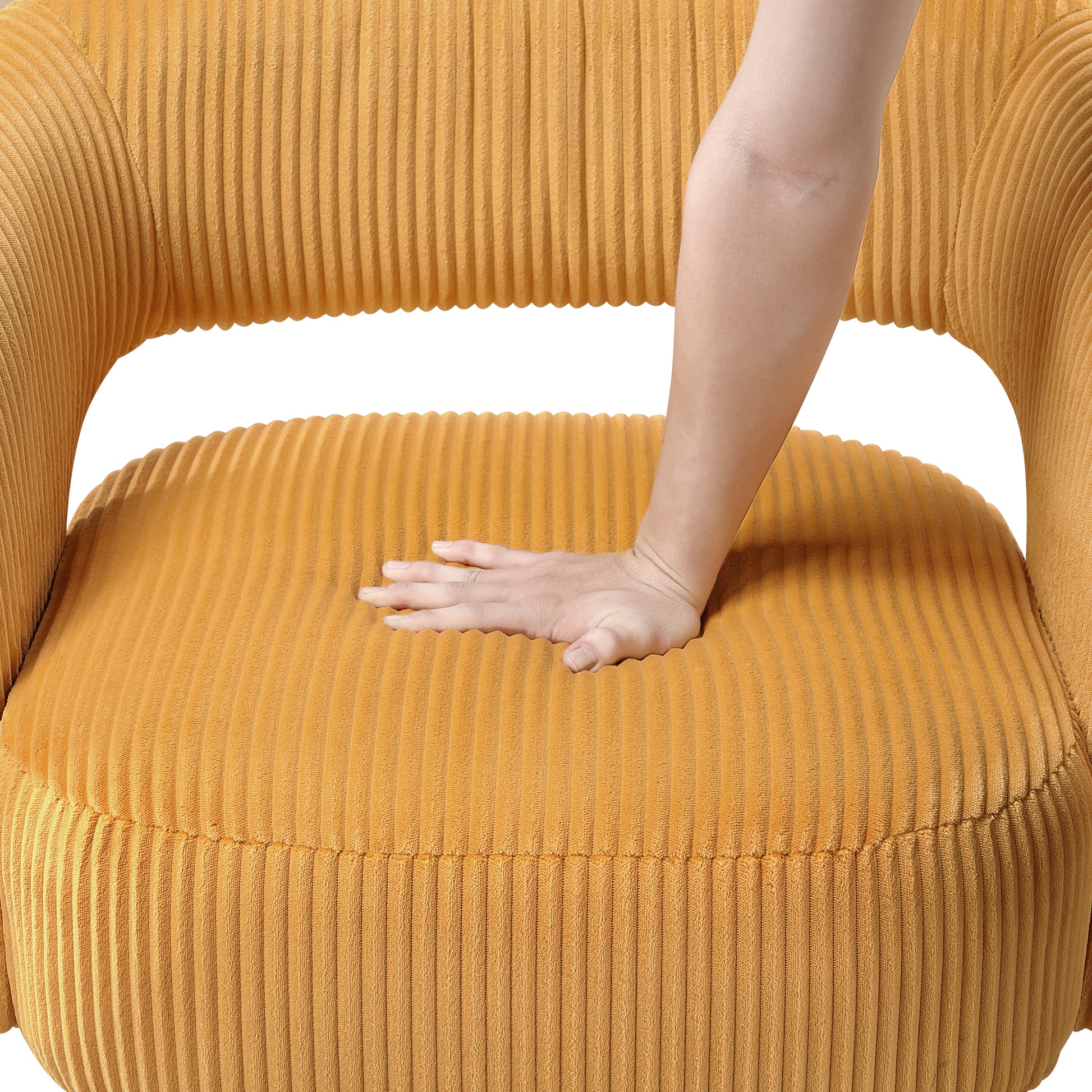 Closeup of a plush yellow corduroy armchair cushion showing the texture of the fabric