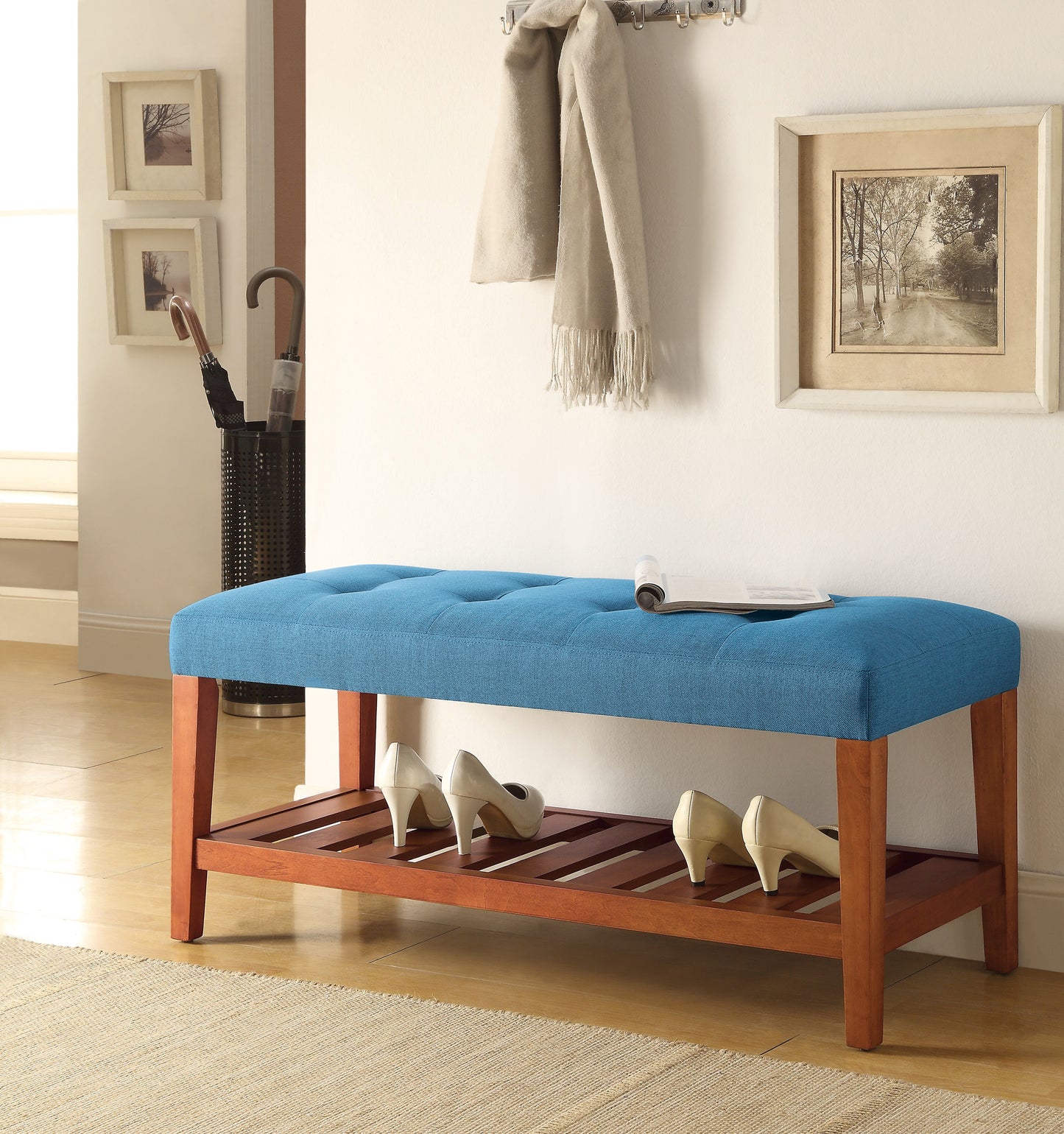 Blue tufted upholstered storage bench with wooden legs and slatted shoe rack