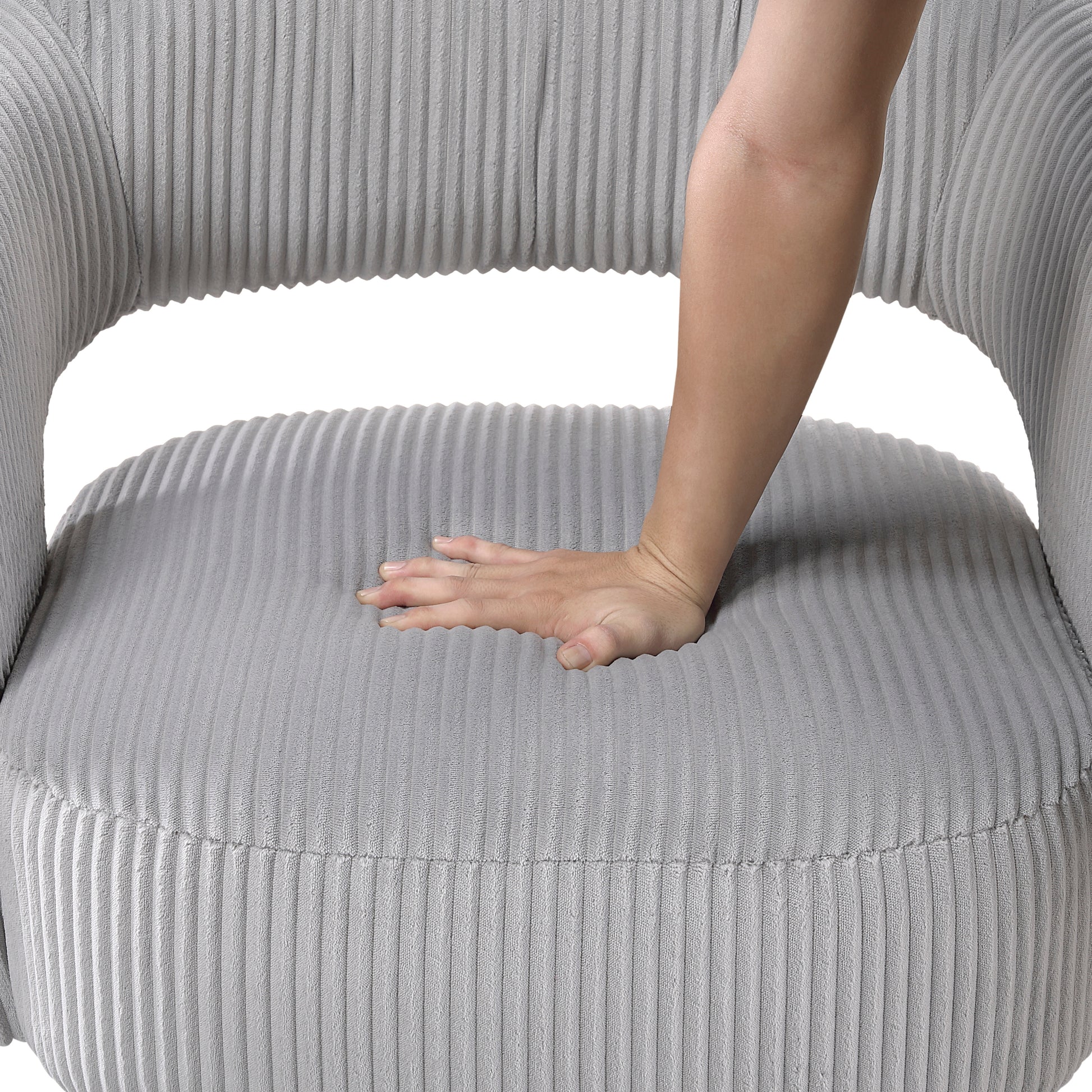 Closeup of plush grey corduroy accent chair seat showing soft yielding comfort