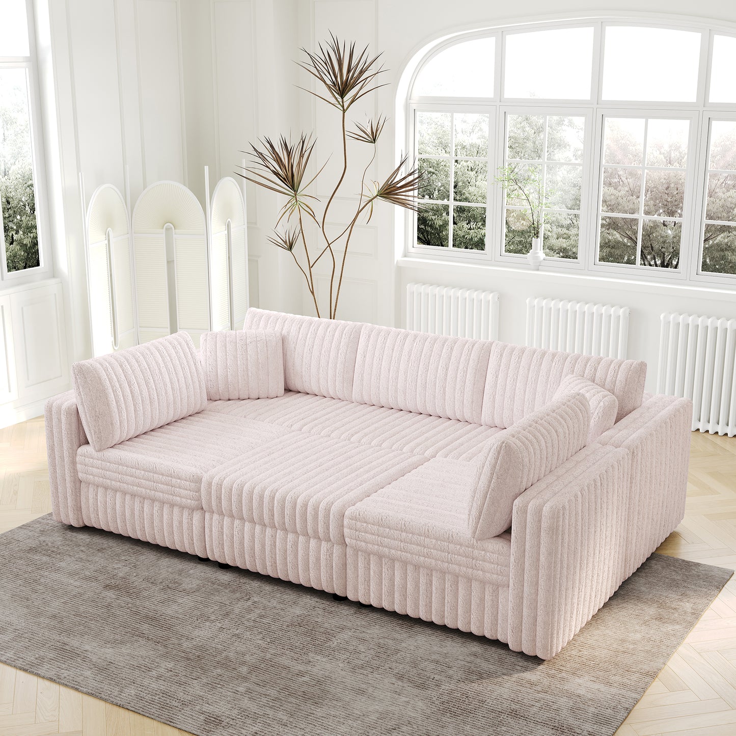 Plush pink corduroy sectional sofa with plush throw pillows perfect for a cozy living room