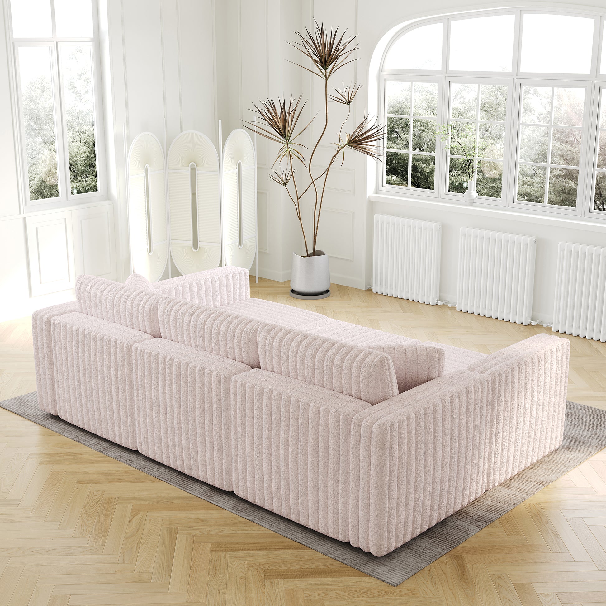 Pale pink corduroy sofa with deep seating and channel tufting modern living room design