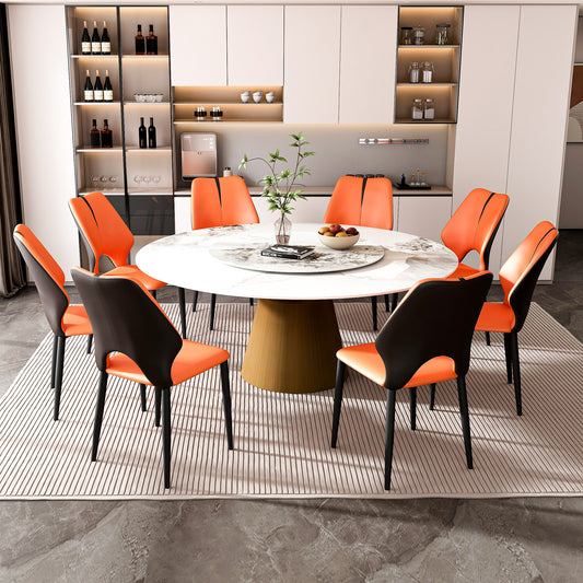 Modern dining set with  orange and black upholstered chairs around a round marble table