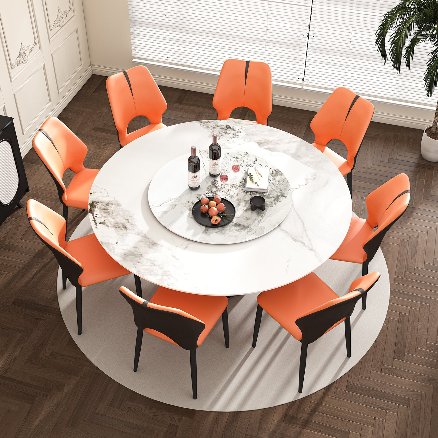 Round marble dining table with eight orange leather chairs