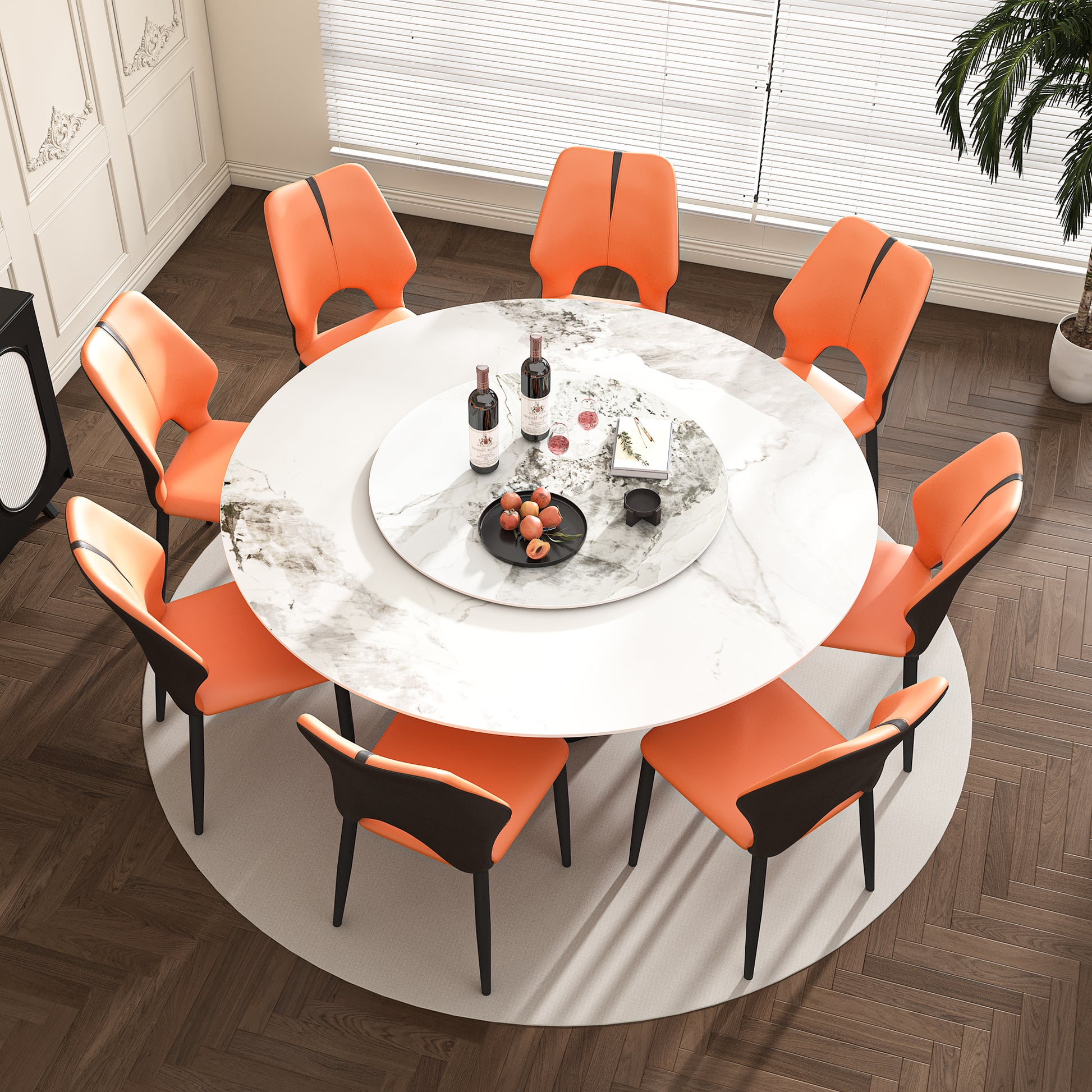 Round marble dining table with eight orange leather chairs