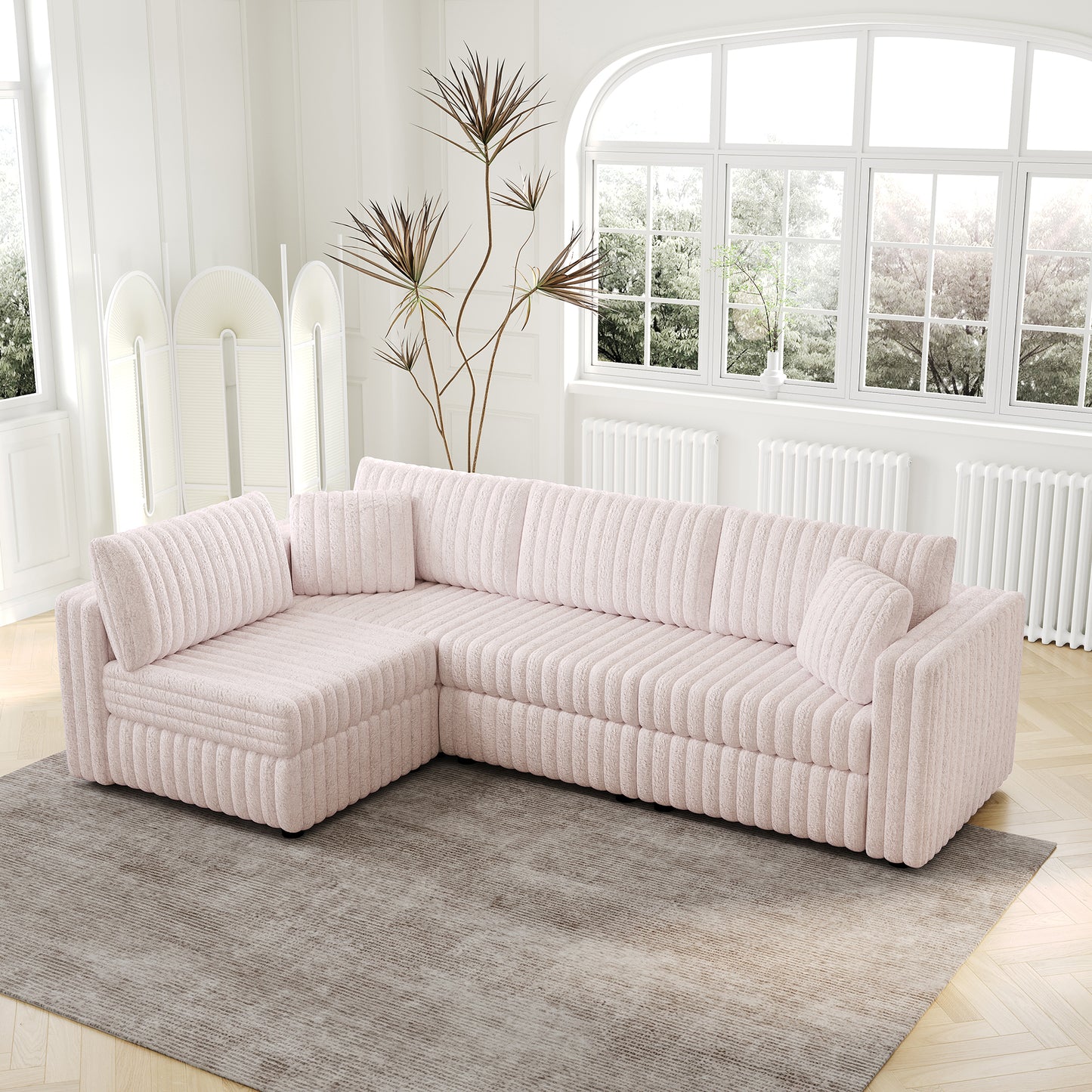 Plush pink sectional sofa with textured fabric and matching throw pillows
