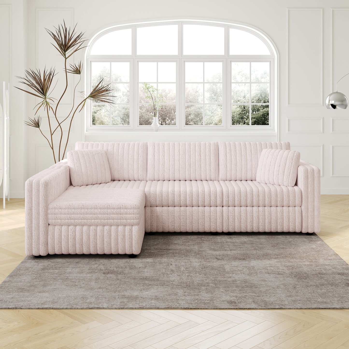Plush pink sectional sofa with textured fabric and matching lumbar pillows