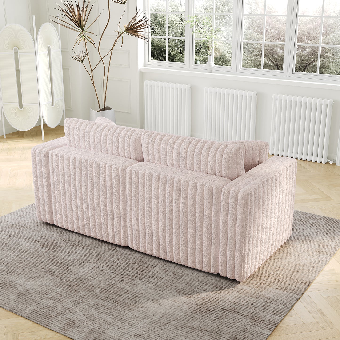 Textured blush pink sofa with plush fabric and vertical channel detailing