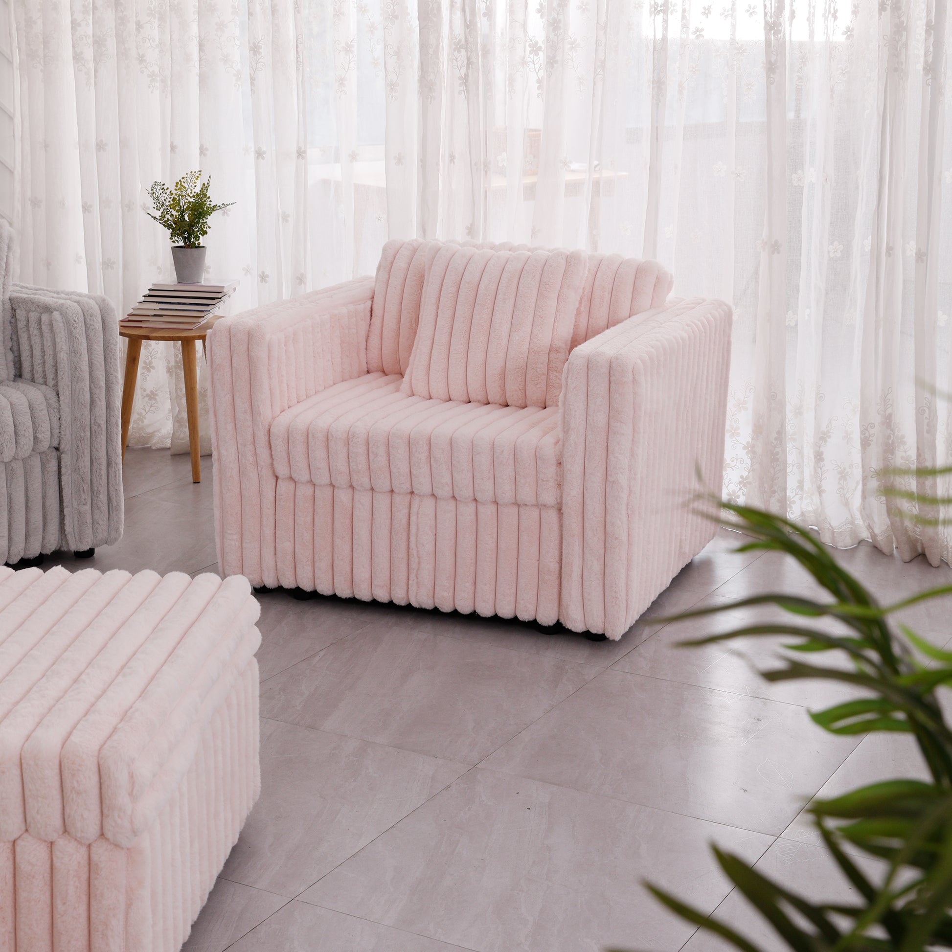 Plush pink armchair with vertical ribbing perfect for cozy living rooms