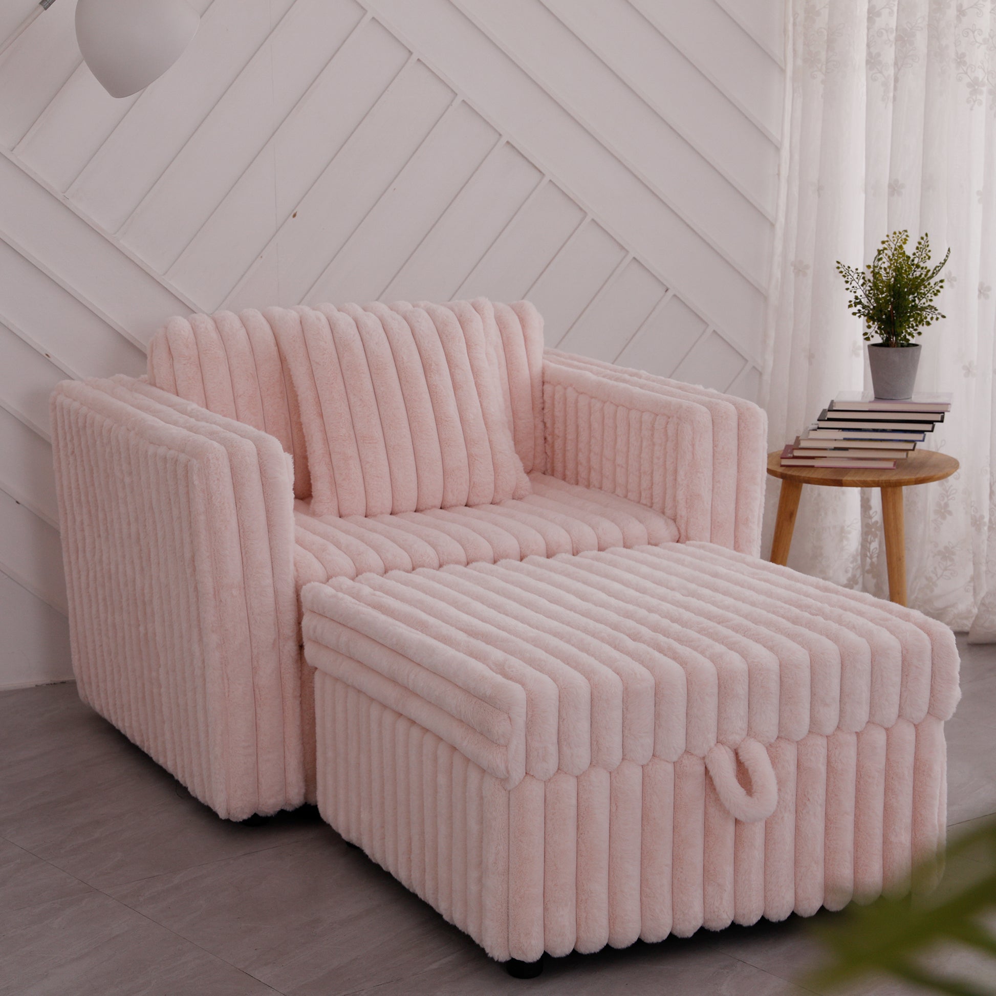 Plush pink sofa bed with vertical ribbing and matching ottoman perfect for small spaces