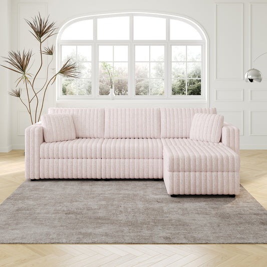 Soft pink textured sectional sofa with plush cushions and ottoman