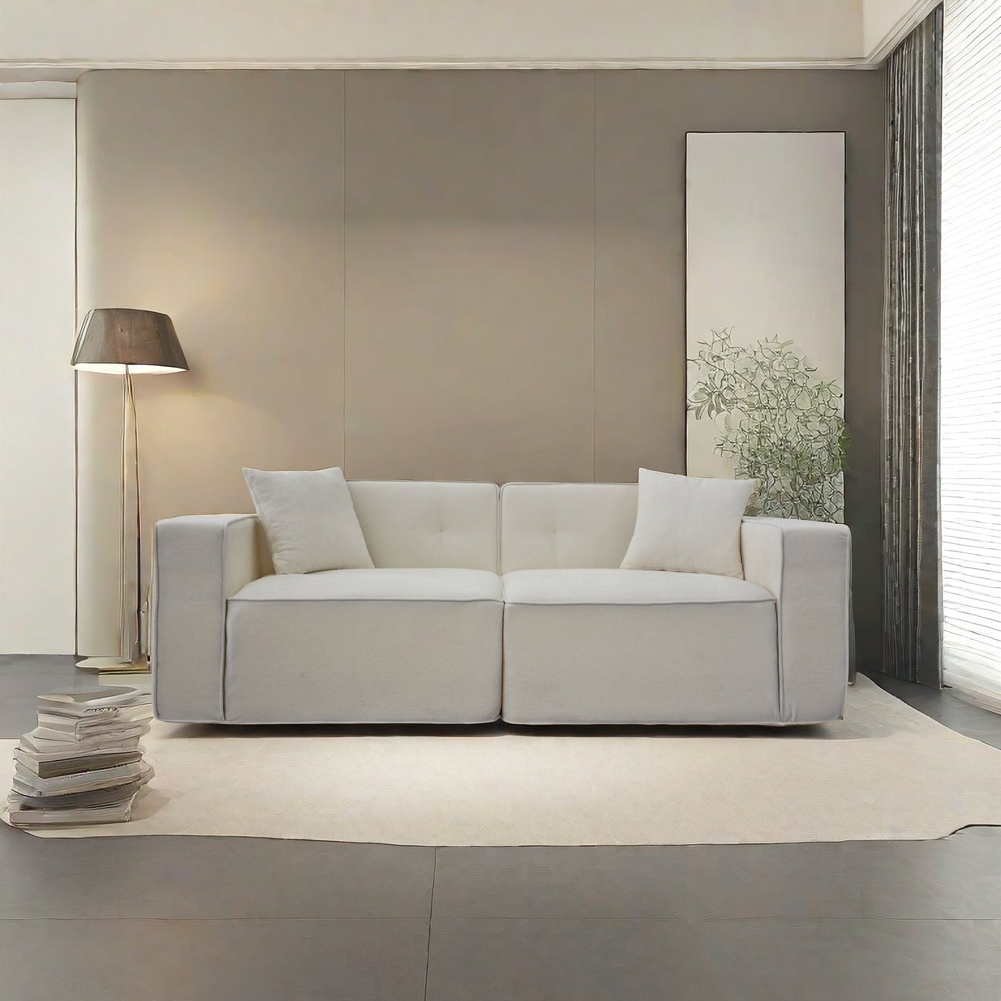 Comfortable white fabric sofa with tufted cushions and lumbar pillows