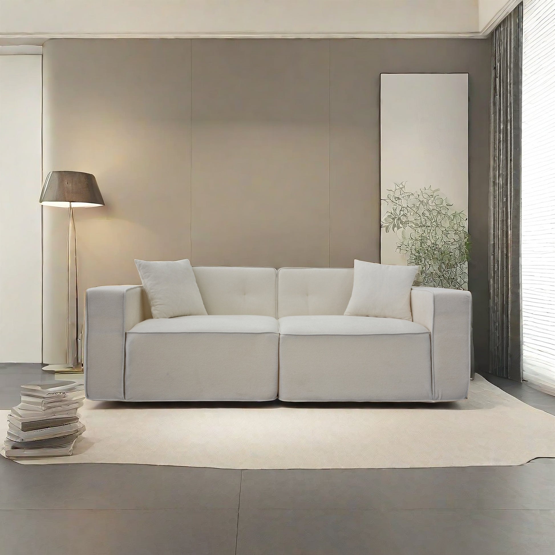 Comfortable white fabric sofa with tufted cushions and lumbar pillows