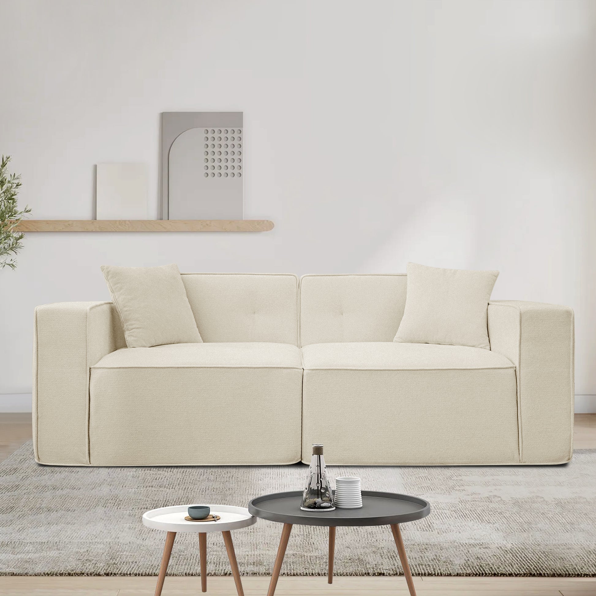 Cream boucle fabric sectional sofa with two throw pillows modern living room seating