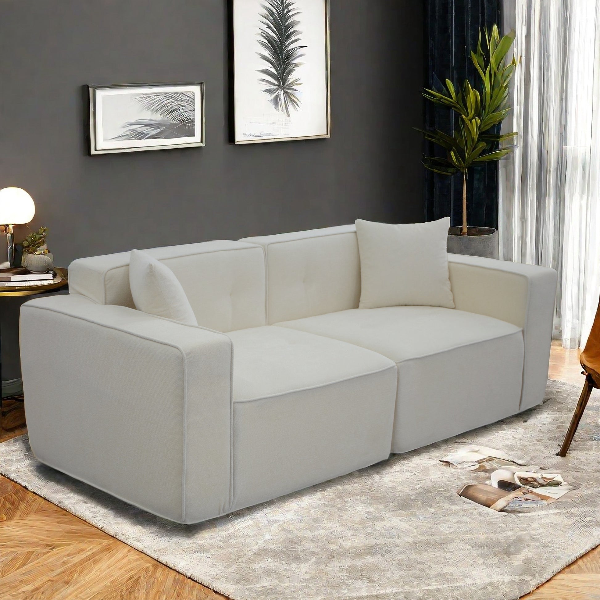 Plush offwhite fabric sofa with modern block design and accent pillows